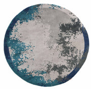 The RAMSHA HOME Modern Blue Round Abstract Rug CMN 121 features a marbled geometric pattern in gray, teal, dark blue, and black, adding a modern touch to any space.