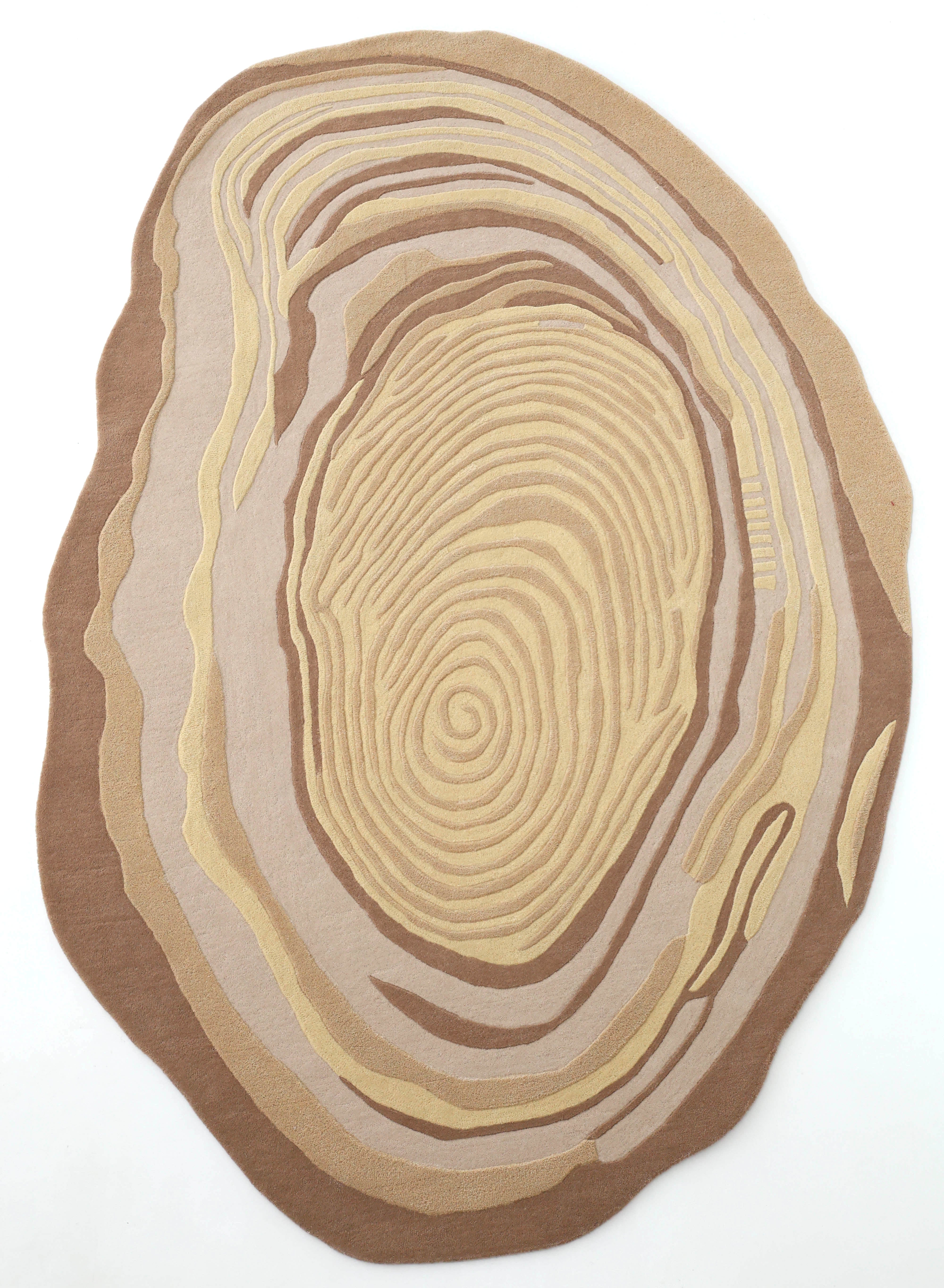 The RAMSHA HOME Terra Eclipse Oval Handmade Rug HTWV-155 features an abstract, irregular oval shape with concentric, flowing lines in beige, tan, and brown tones on a white background.