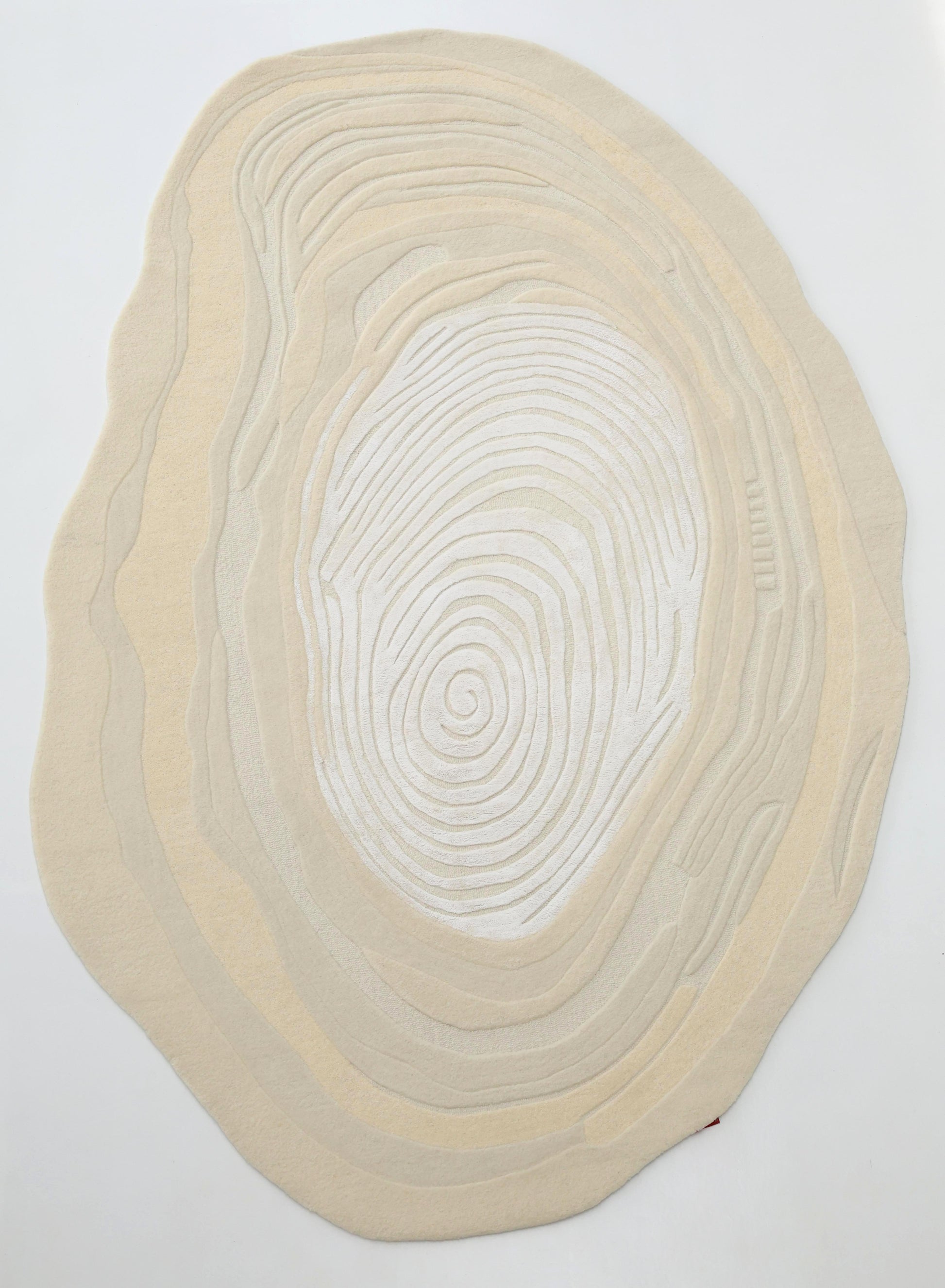 The RAMSHA HOME Ivory Topographic Shaped Rug 200x300 cm (HTWV-192) features modern, irregular shaping with wavy concentric lines like tree rings or topography, set against an ivory background.