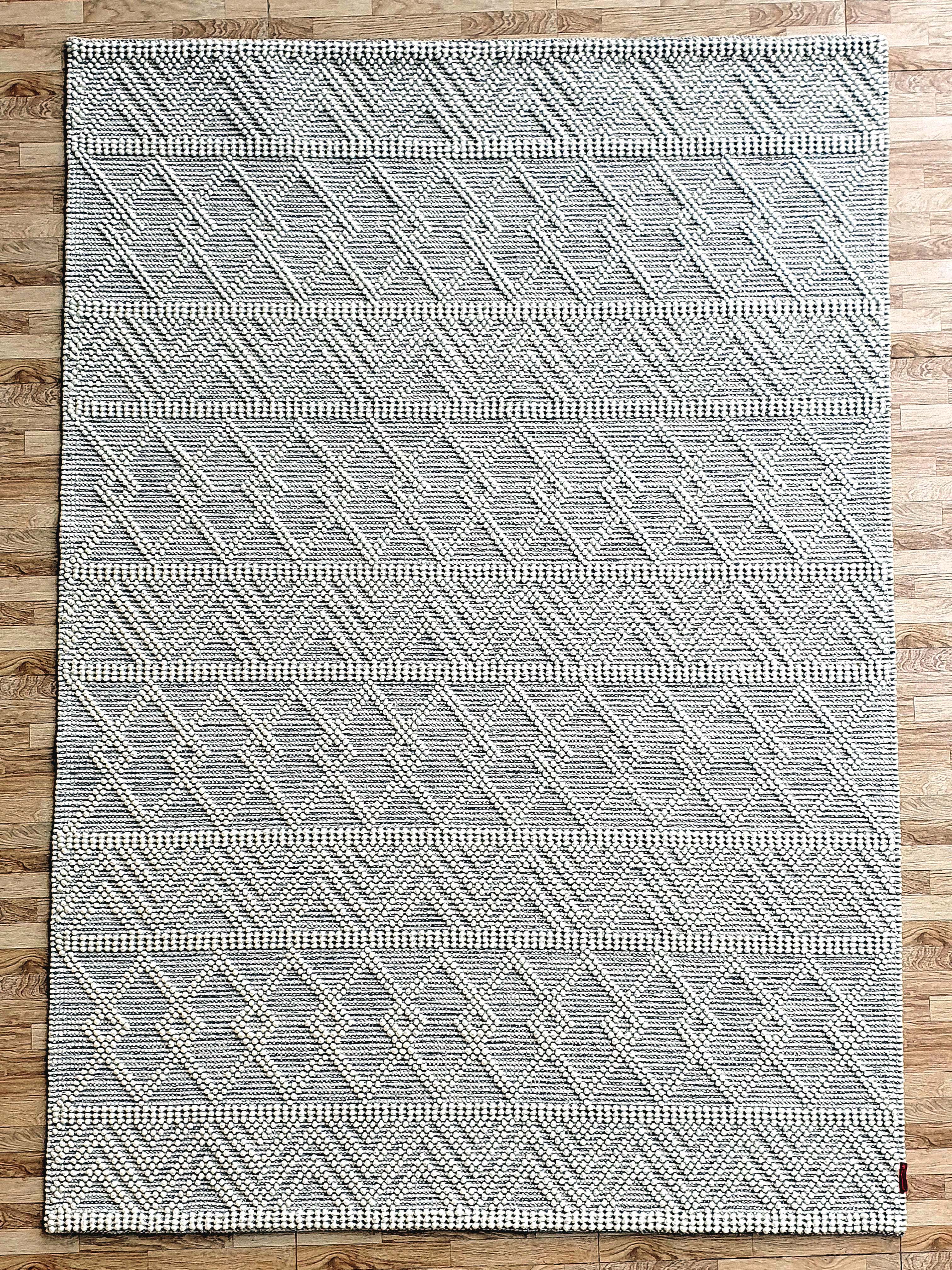 The RAMSHA HOME Handmade Woven Rug SRN-021 features a natural and white geometric diamond pattern, ideal for adding modern style to any space. Perfect as a chic floor rug on light wood floors.