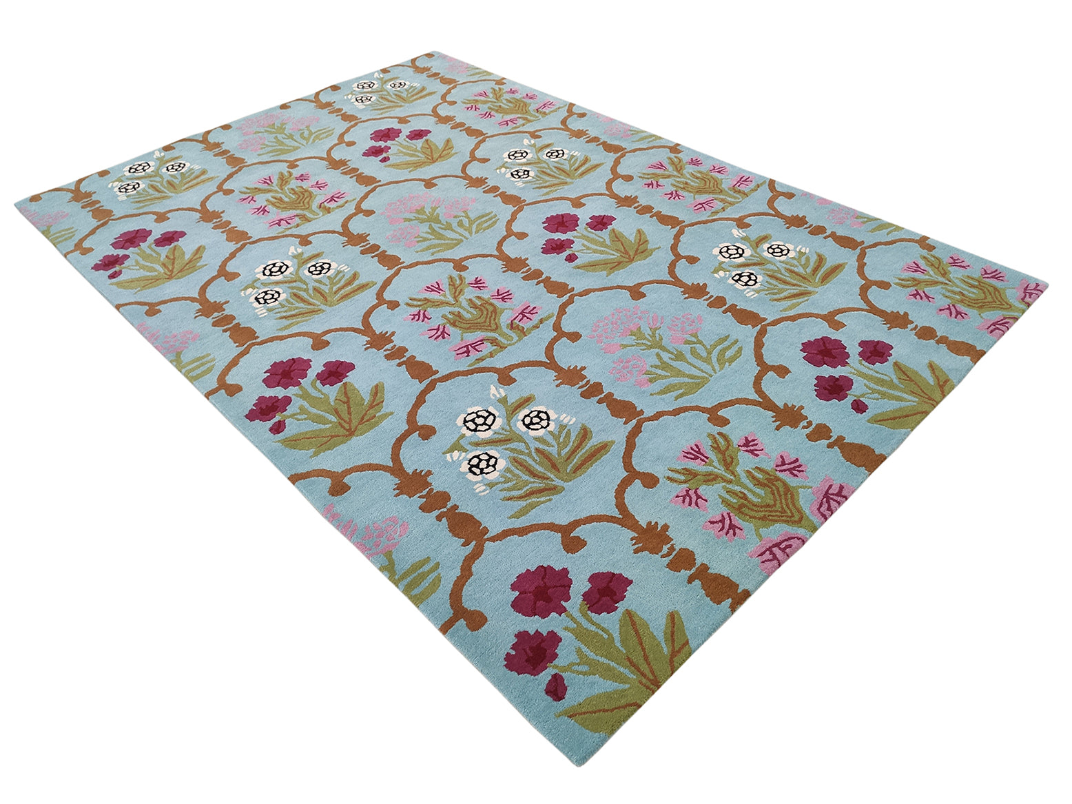 The RAMSHA HOME Handmade Blue Floral Wool Carpet (202x292 cm, HTW-25) features a light blue background and a lattice-style floral pattern in pink, green, brown, and white.
