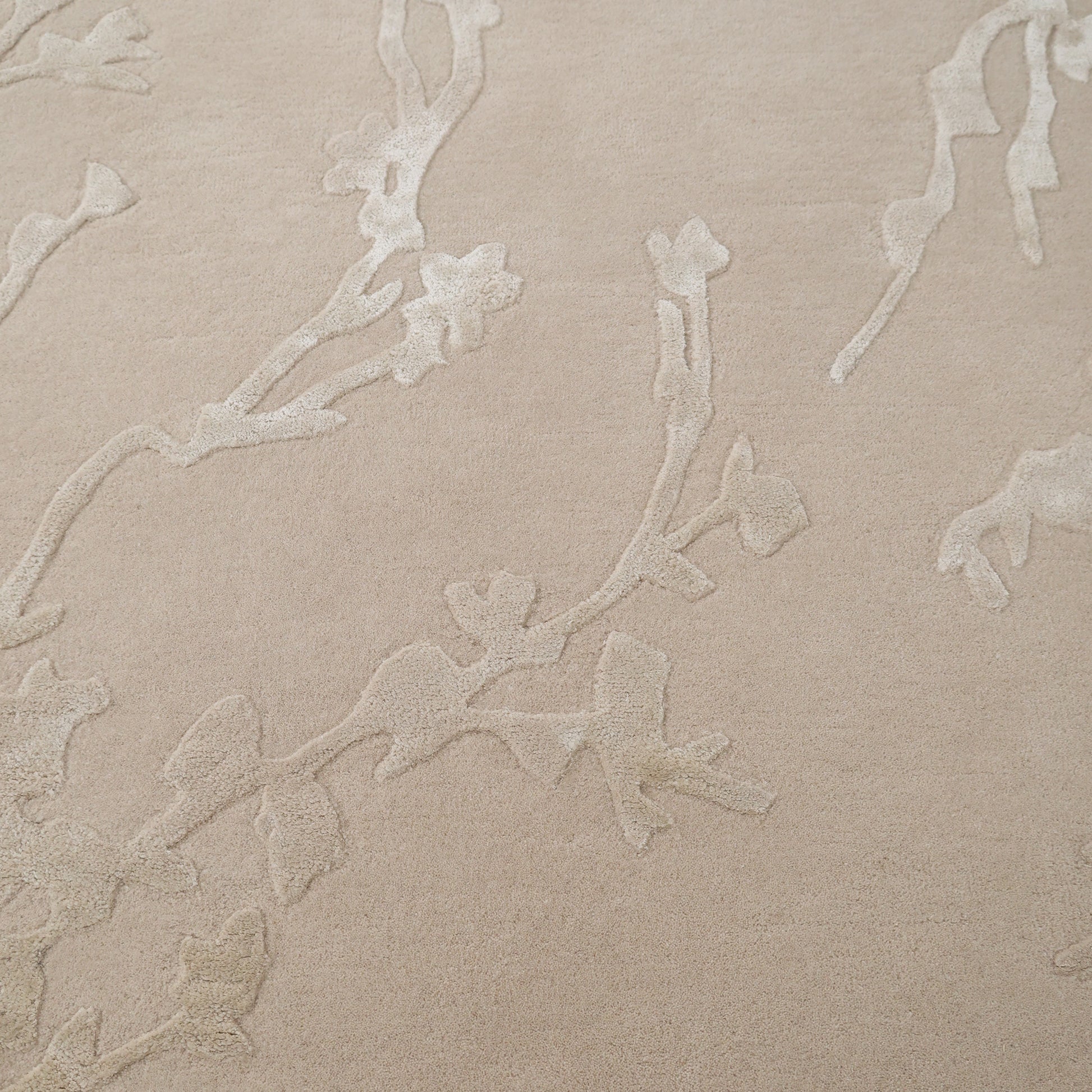 The RAMSHA HOME Decorative Handmade Area rug HTWV-118 features a beige floral textured design with a subtle raised branch pattern, adding warmth and elegance to your bedroom as a neutral accent piece.