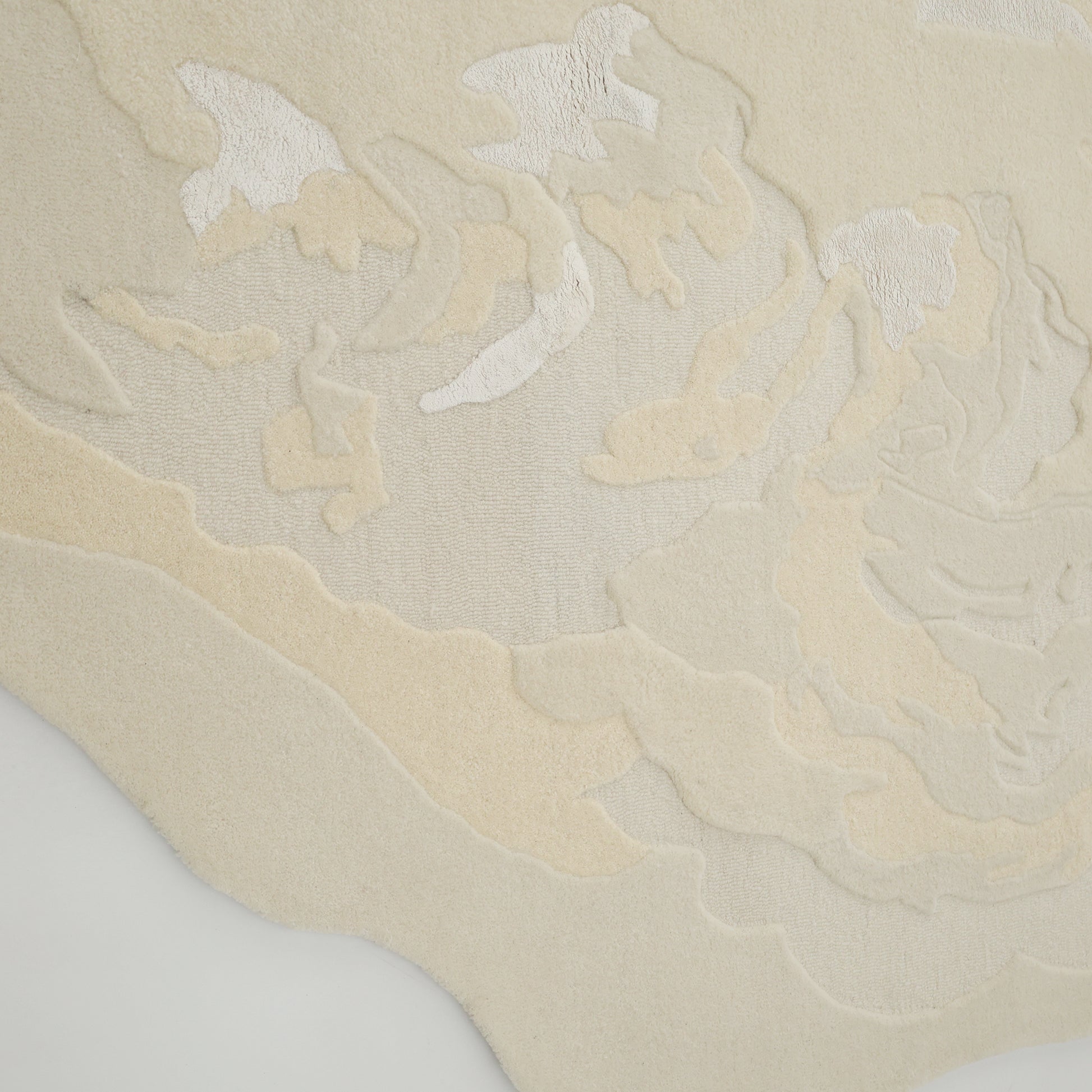 The Stylish Handmade Shape Rug Multi Color HTWV-105 by RAMSHA HOME is a hand-tufted wool rug with cream and beige tones, featuring abstract shapes and textured surfaces for a unique, cloud-like depth and movement.
