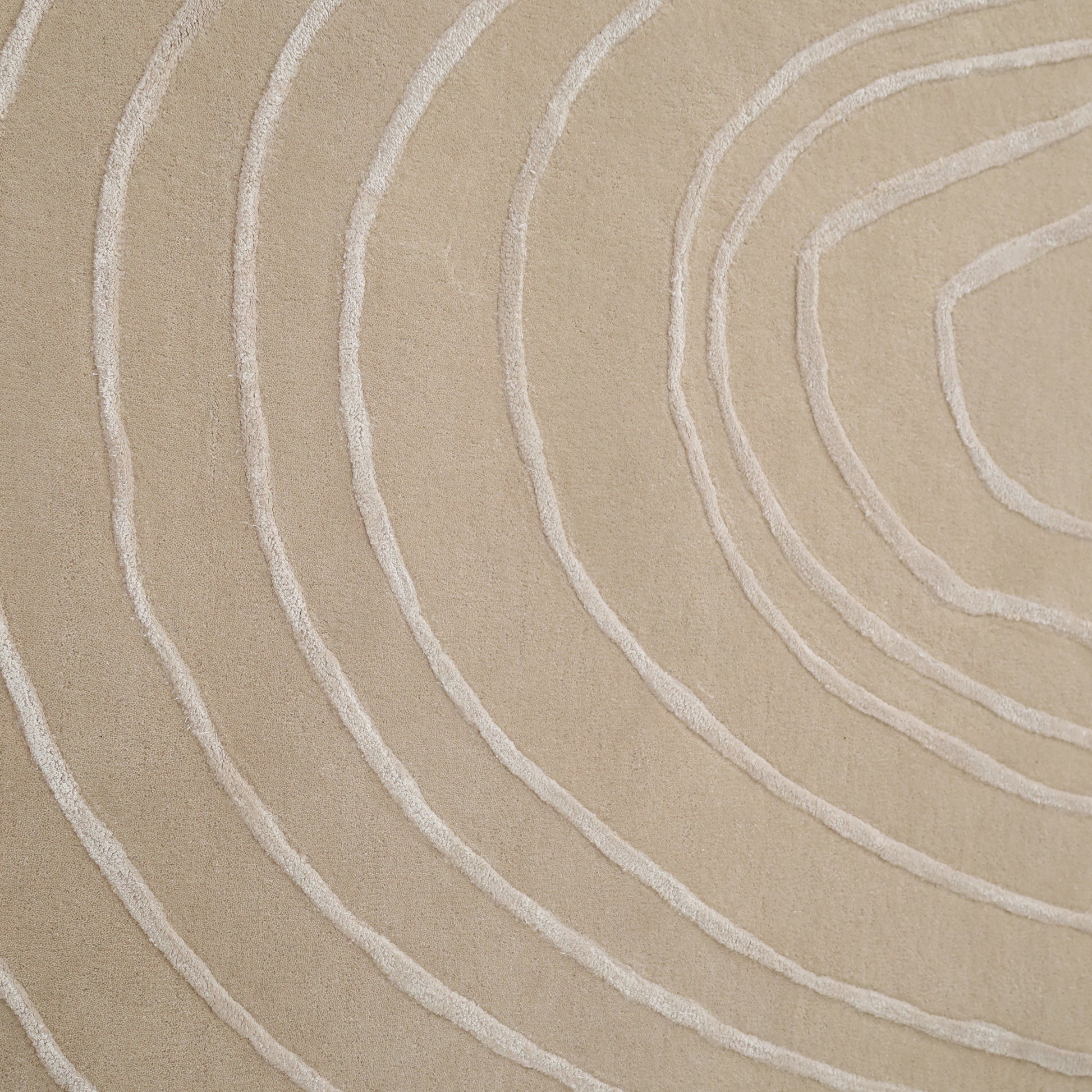 The Luxurious Off-White Wool & Tencel Handmade Area Rug - HTWV 110 (200x300cm) from RAMSHA HOME features raised, textured curves resembling tree rings, creating a minimalistic and organic abstract pattern ideal for modern interiors.