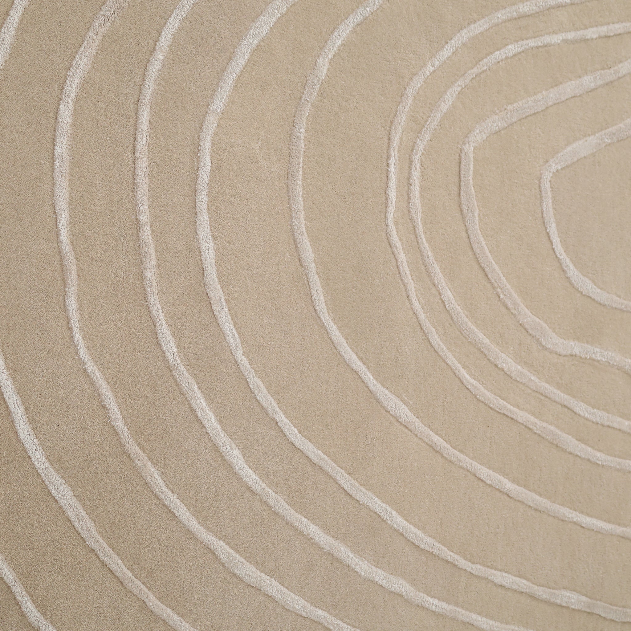 The Luxurious Off-White Wool & Tencel Handmade Area Rug - HTWV 110 (200x300cm) from RAMSHA HOME features raised, textured curves resembling tree rings, creating a minimalistic and organic abstract pattern ideal for modern interiors.
