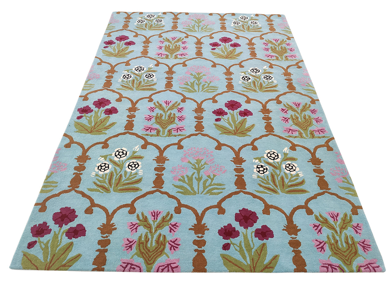 The RAMSHA HOME Handmade Blue Floral Wool Carpet 202x292 cm (HTW-25) features a light blue base with symmetrical rows of red, pink, white, and green florals framed by brown arches for an elegant, hand-tufted design.