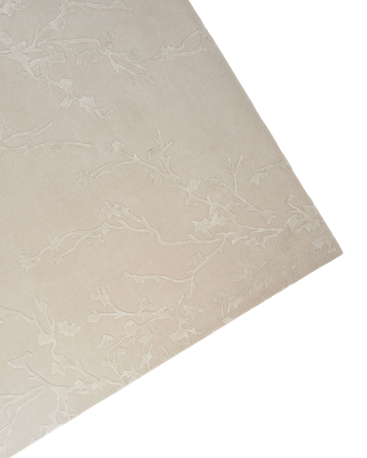 The Handmade beige Color Decor Rug- HTWV 115 by RAMSHA HOME, featuring a subtle, raised floral and vine motif, is displayed from an angled top-down perspective in the lower right corner of the image. Crafted from hand-tufted wool, this elegant rectangular rug offers lasting softness and texture.