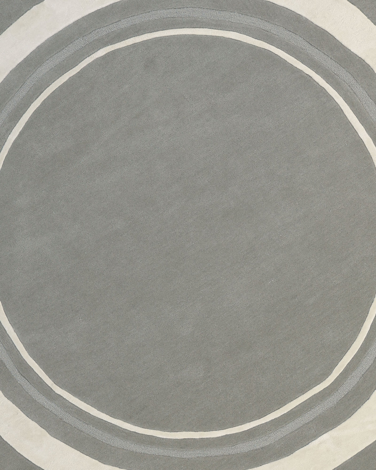 The Grey & White Color Round Handmade Rug - HTWV-121 by RAMSHA HOME features a minimalist and modern abstract design with a gray surface accented by two off-white concentric circles near the edges. This handmade rug captures the sophisticated contrast of grey and white, making it an ideal round area rug centerpiece for contemporary interiors.
