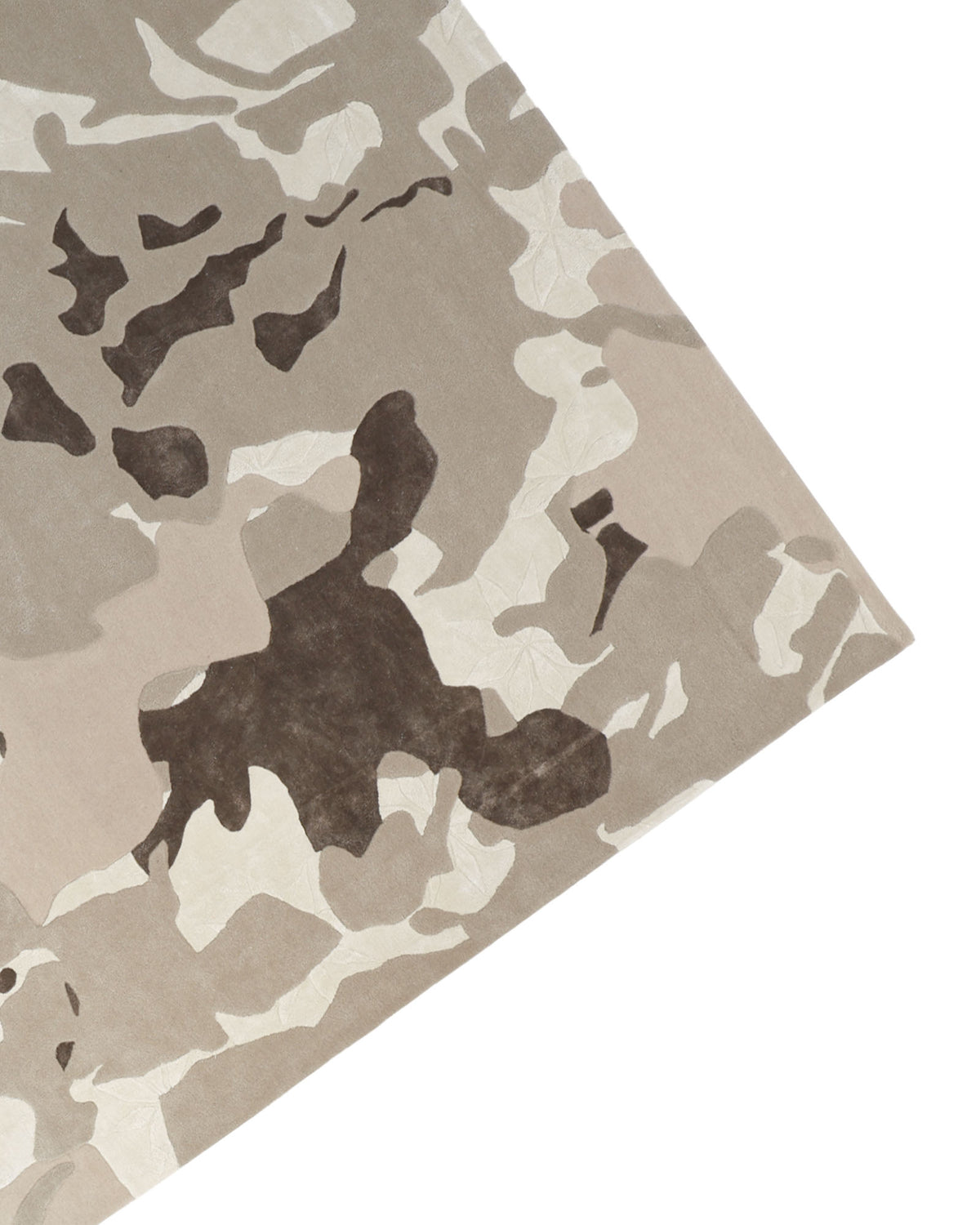 A close-up view of the RAMSHA HOME Abstract Wool & Viscose Handmade Carpet 300x400 – HTWV-180, highlighting its beige, brown, and cream camouflage-inspired pattern at an angle—capturing the intricate texture characteristic of a hand-tufted rug.