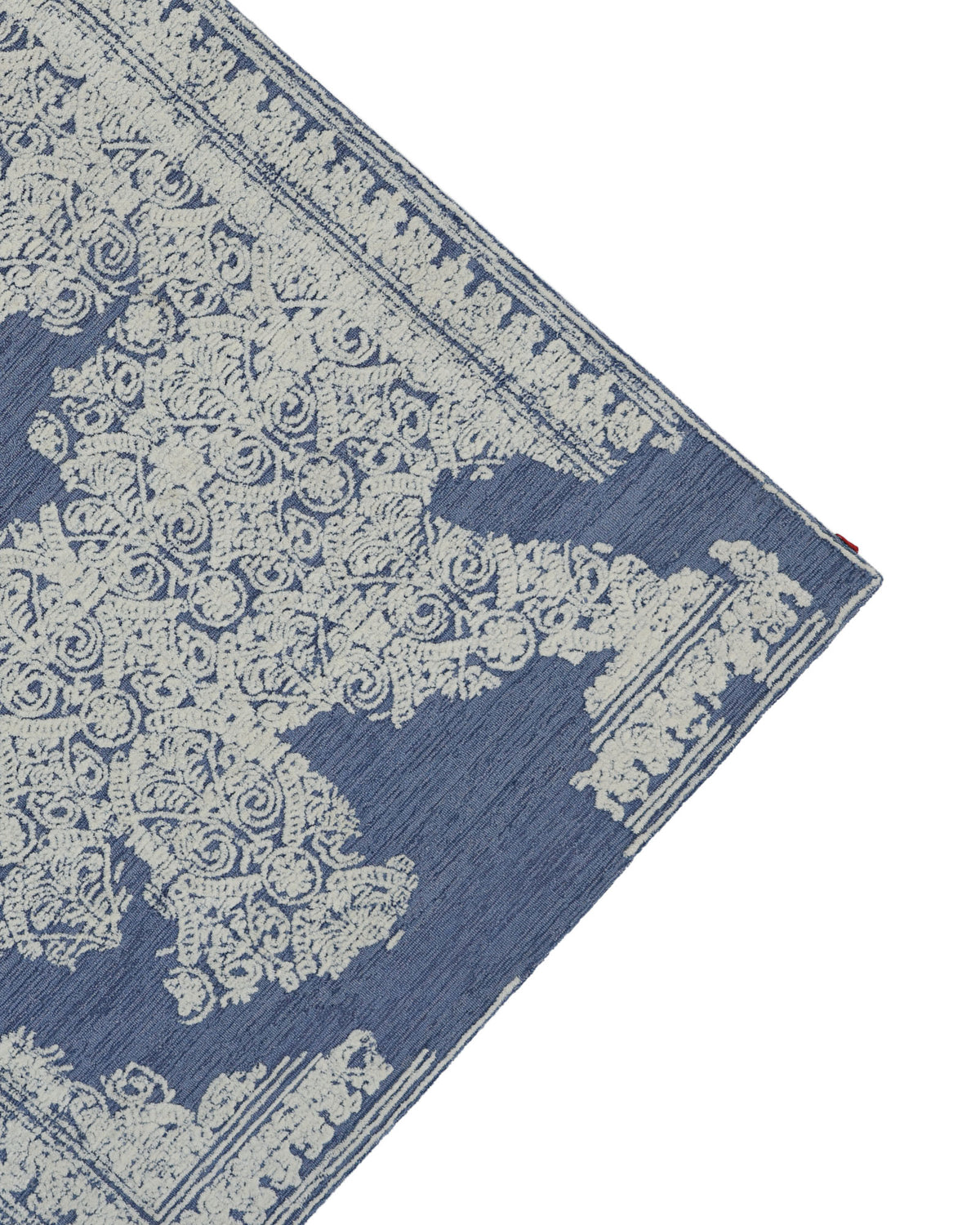 Corner of the Blue Mosaic Handcrafted Luxury Area Rug- HTW 145 by RAMSHA HOME, featuring an ornate cream-colored floral and geometric pattern with a decorative border, photographed against a white background—this vintage-inspired rug brings timeless elegance to any space.