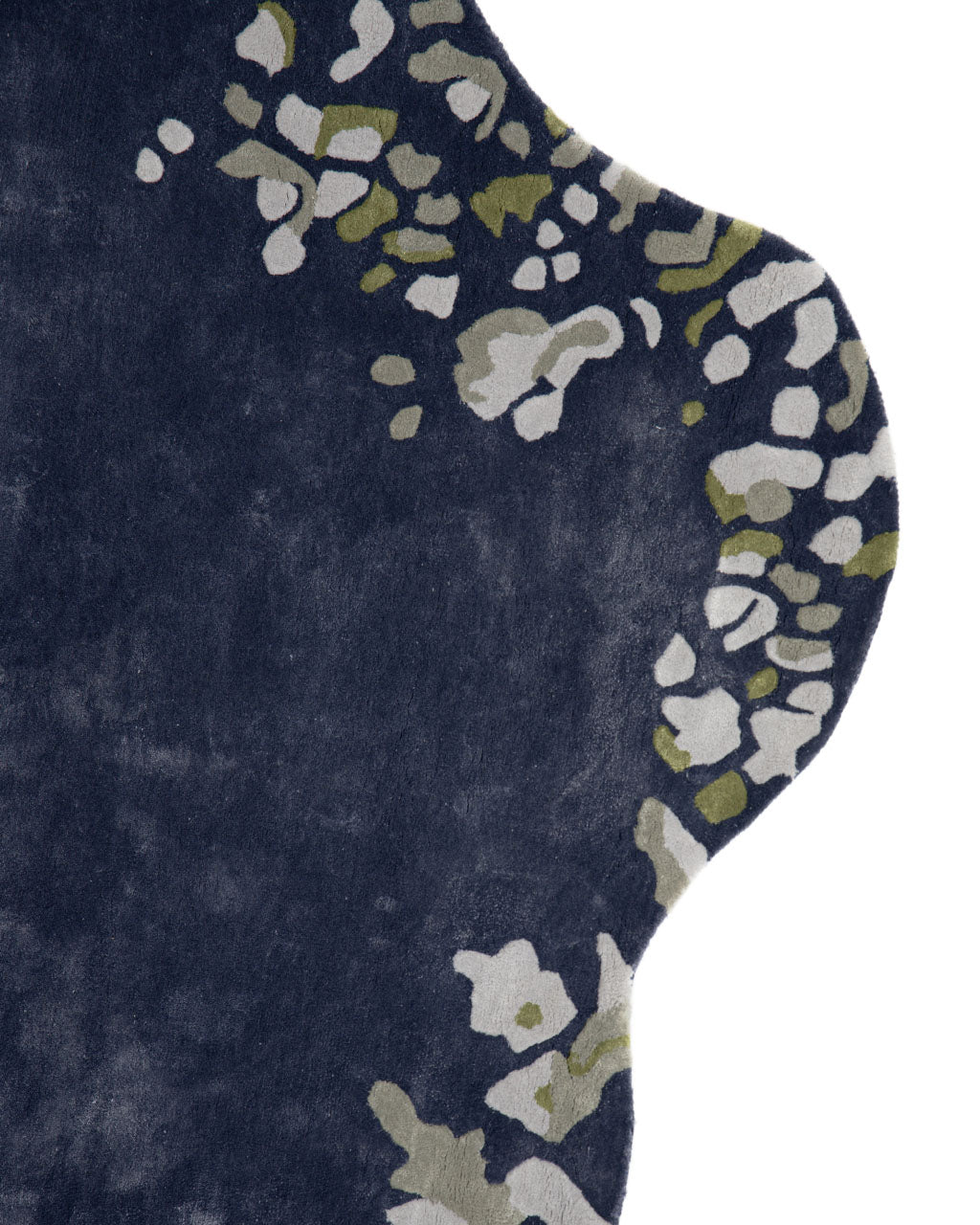 The curved edge of the Navy Blue Viscose Shaped Handmade Carpet 200x300 - HTV-23 by RAMSHA HOME features an irregular border with abstract green, white, and gray floral patterns, beautifully crafted as a hand-tufted rug.