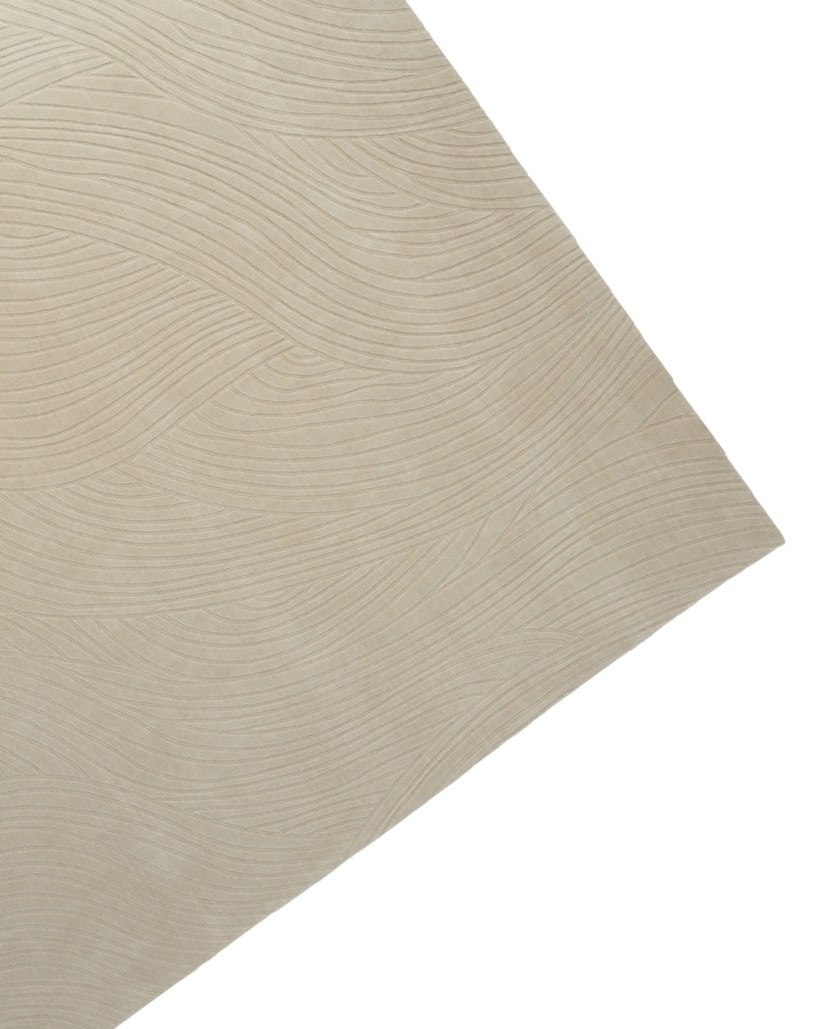 A close-up of the RAMSHA HOME Decorative Rectangle Handmade Beige Color 300x400 cm Area Rug (LKH-033) showcases its textured surface with subtle, wavy lines reminiscent of gentle waves or wood grain, presented at an angle. The surface appears smooth and soft.