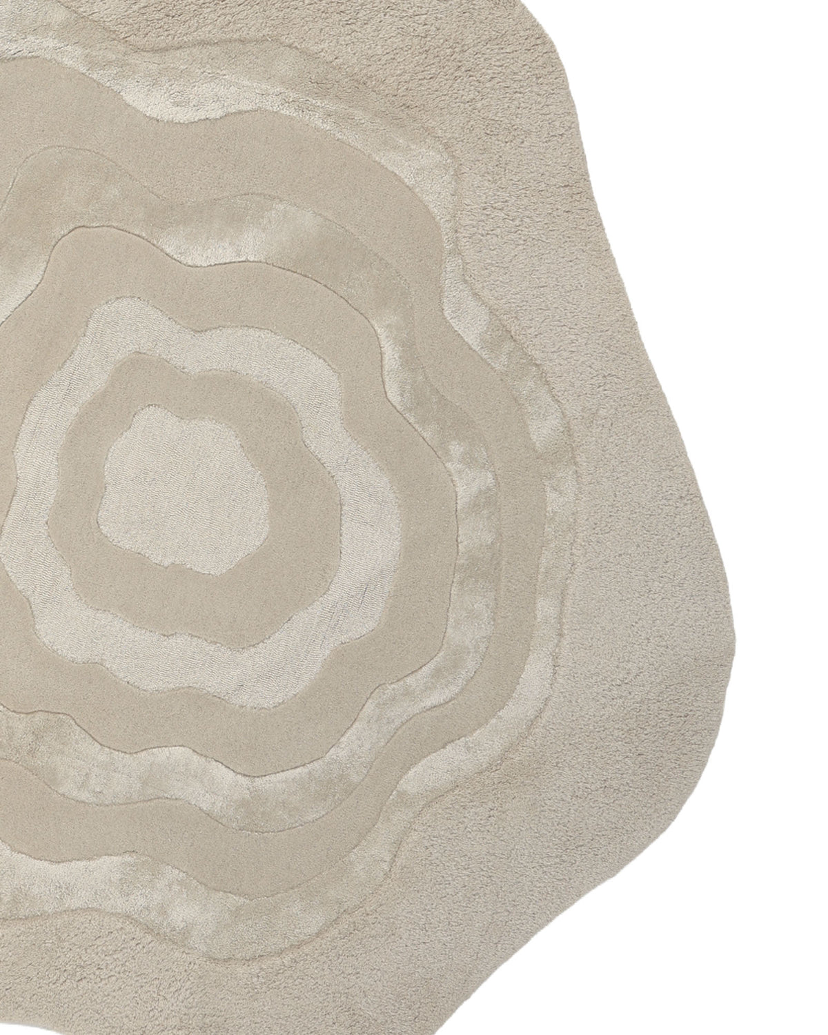 The RAMSHA HOME Multi Color Handmade Area Rug - HTWV 148 is an irregularly shaped, neutral area rug hand tufted from a wool blend. It features layered, wavy patterns in multiple shades of beige that evoke the look of a topographic map or organic rings.