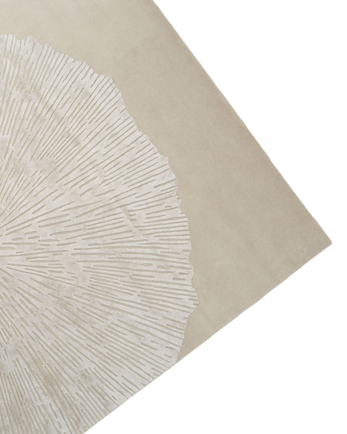 The RAMSHA HOME Hand-Tufted Carpet For Home Decor HTWV-76 is a beige contemporary wool area rug featuring a textured, radial pattern reminiscent of tree rings. Displayed at an angle with only one corner and its distinctive design visible, this hand-tufted rug offers a striking yet neutral accent for any modern interior.