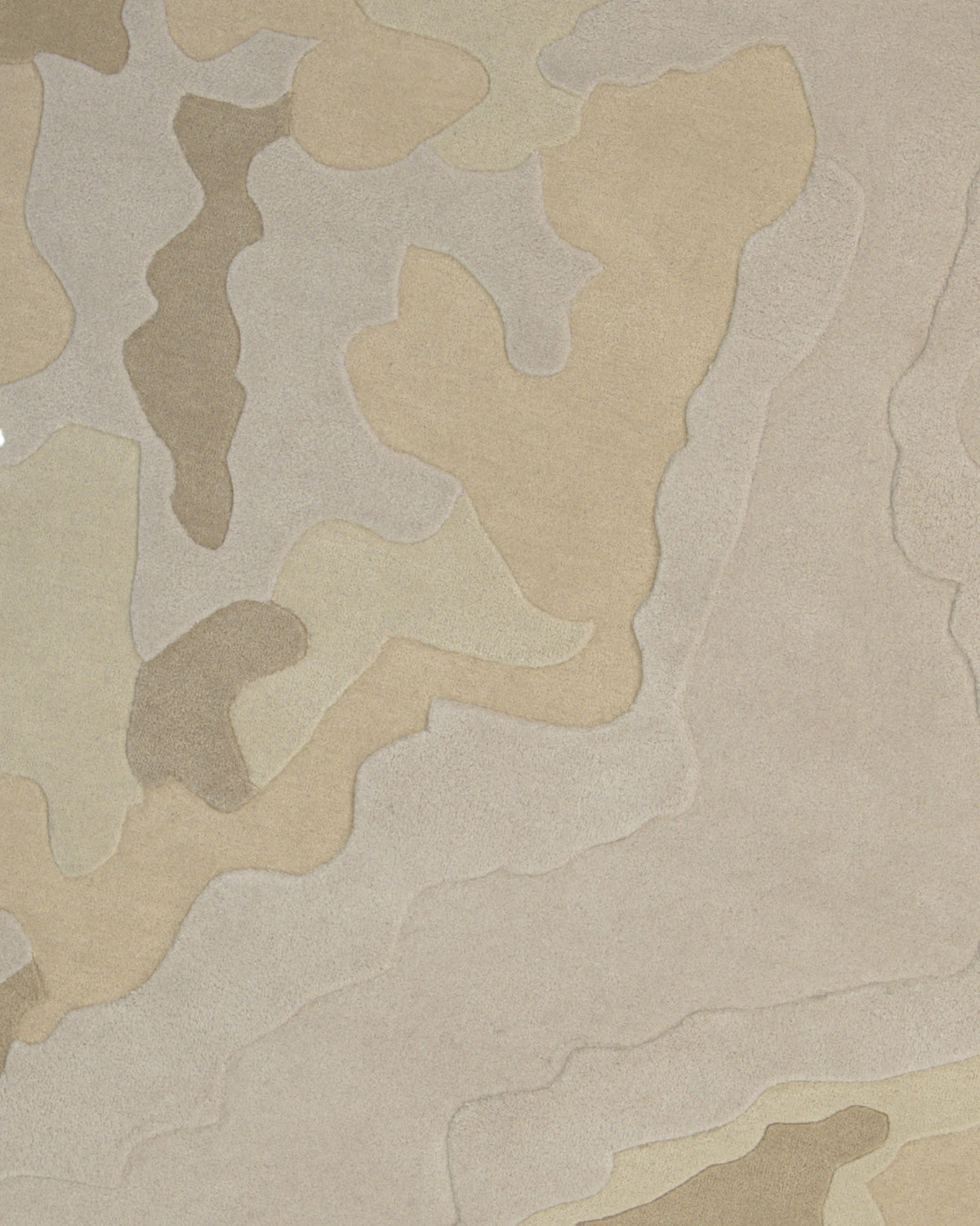The Contemporary Flow Area Handmade Rug HTW-153 by RAMSHA HOME features a beige and tan camouflage pattern with irregular, overlapping shapes in various shades, creating a textured, natural look inspired by desert terrain—an ideal choice for adding subtle sophistication to any modern interior.