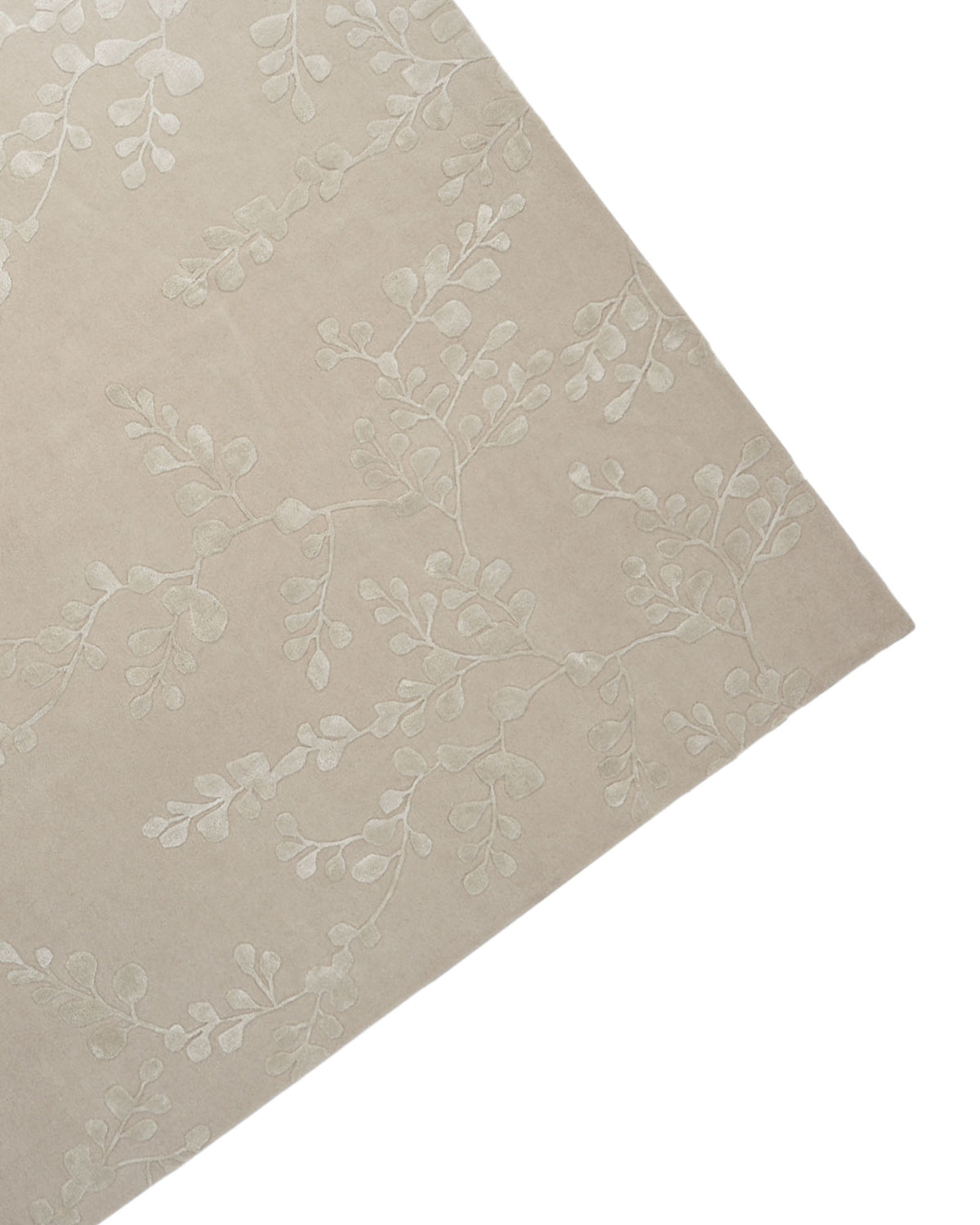 A close-up of the RAMSHA HOME Artisan Handmade Decorative Area Rug – HTWV-116 in beige, featuring a subtle, raised leafy vine pattern, shown at an angle against a white background.