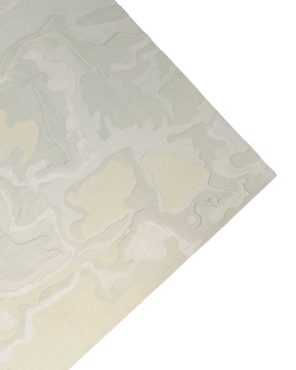 A closeup of the RAMSHA HOME Handcrafted Natural White Area Rug – HTWV-129 reveals its wavy, layered pattern in shades of cream, beige, and off-white—making this handtufted piece an elegant addition to any space.