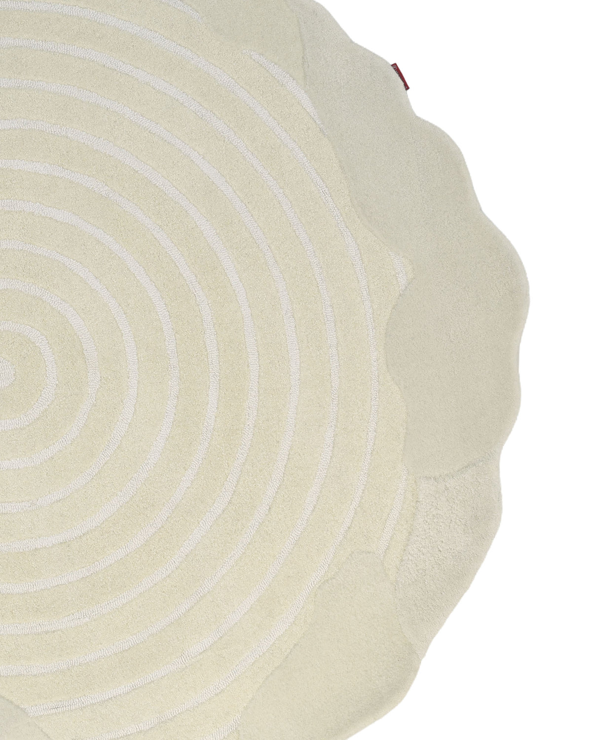 A close-up of the Natural White Color Handmade Area Rug - HTWV-138 (183 x 200 cm) by RAMSHA HOME, featuring a round, cream-colored design with concentric circular patterns and a scalloped edge, photographed against a white background.