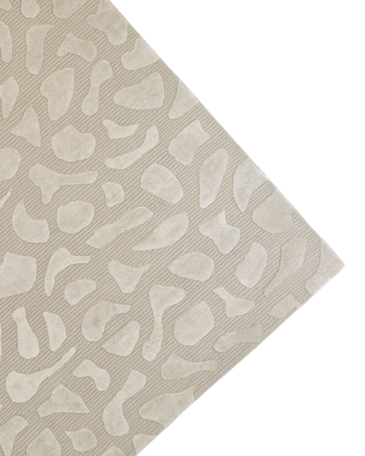 The RAMSHA HOME Modern Beige Textured Rug – HTWV 203 showcases an abstract organic pattern of irregular, raised shapes on a textured beige background, presented from an angled corner view against a white surface.