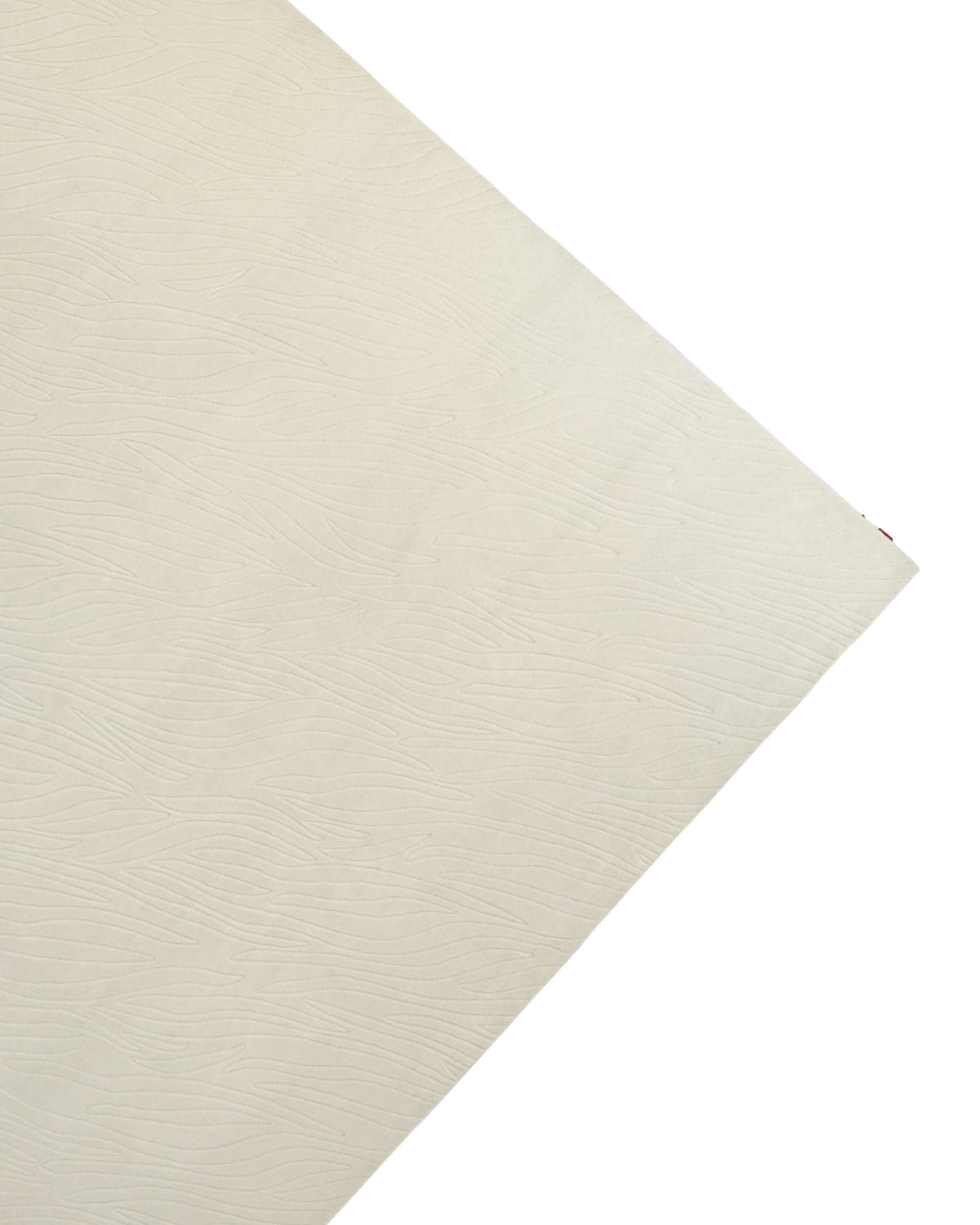 A close-up view of the RAMSHA HOME Natural White Color Handmade Area Rug - HTW-89 (300x400 CM) showcases its textured, off-white surface photographed diagonally, with subtle wavy lines that evoke the delicate patterns of minimalist design.