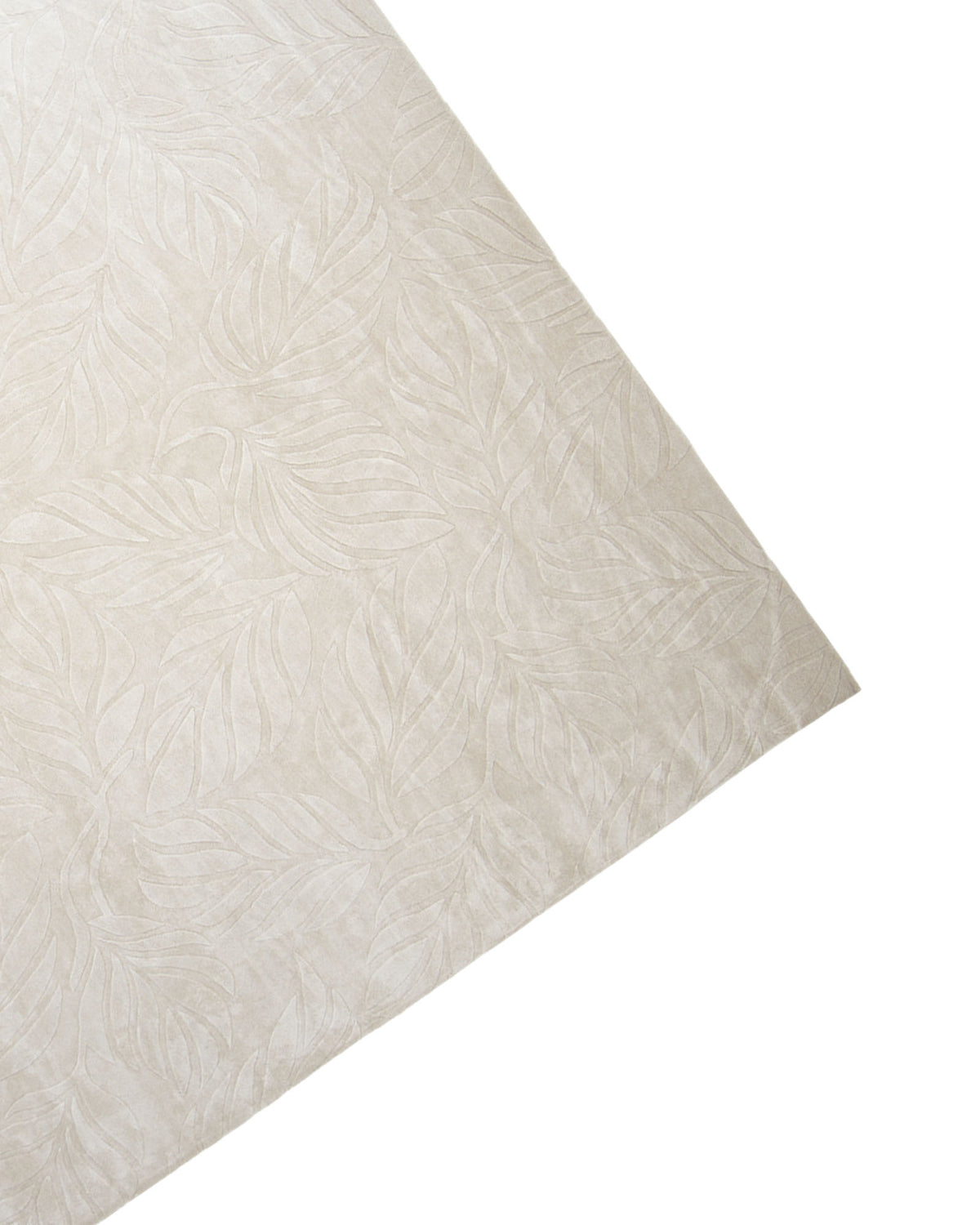 A close-up of the RAMSHA HOME Beige Color Indoor Handmade Area Rug - HTV 15, showcasing its subtle, raised leaf pattern in beige, displayed at an angle on a white background.