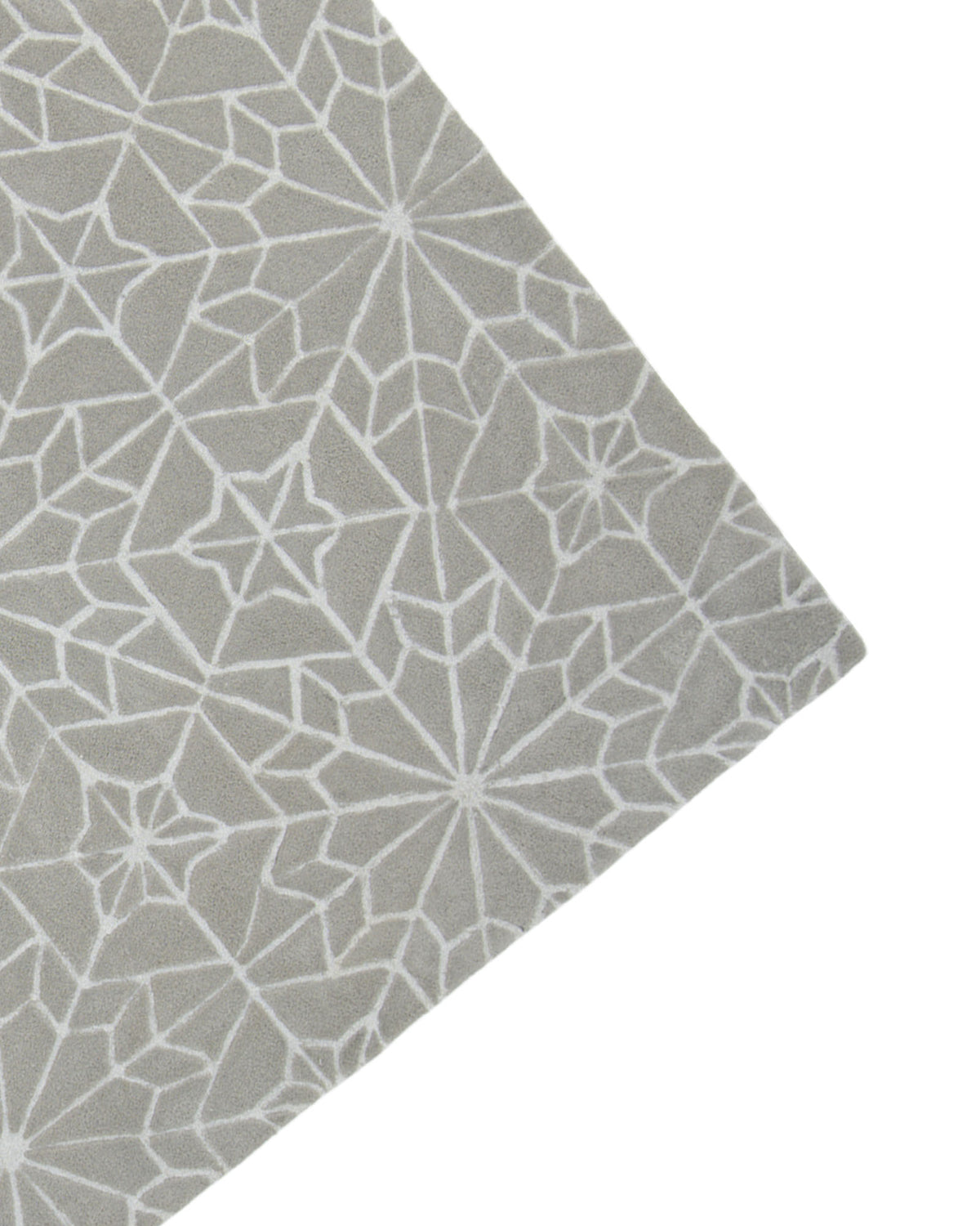A corner of the RAMSHA HOME Modern Rectangle Area Rug Multi Color HTP-18, featuring a gray geometric design with white star and web-like patterns on a plain background.