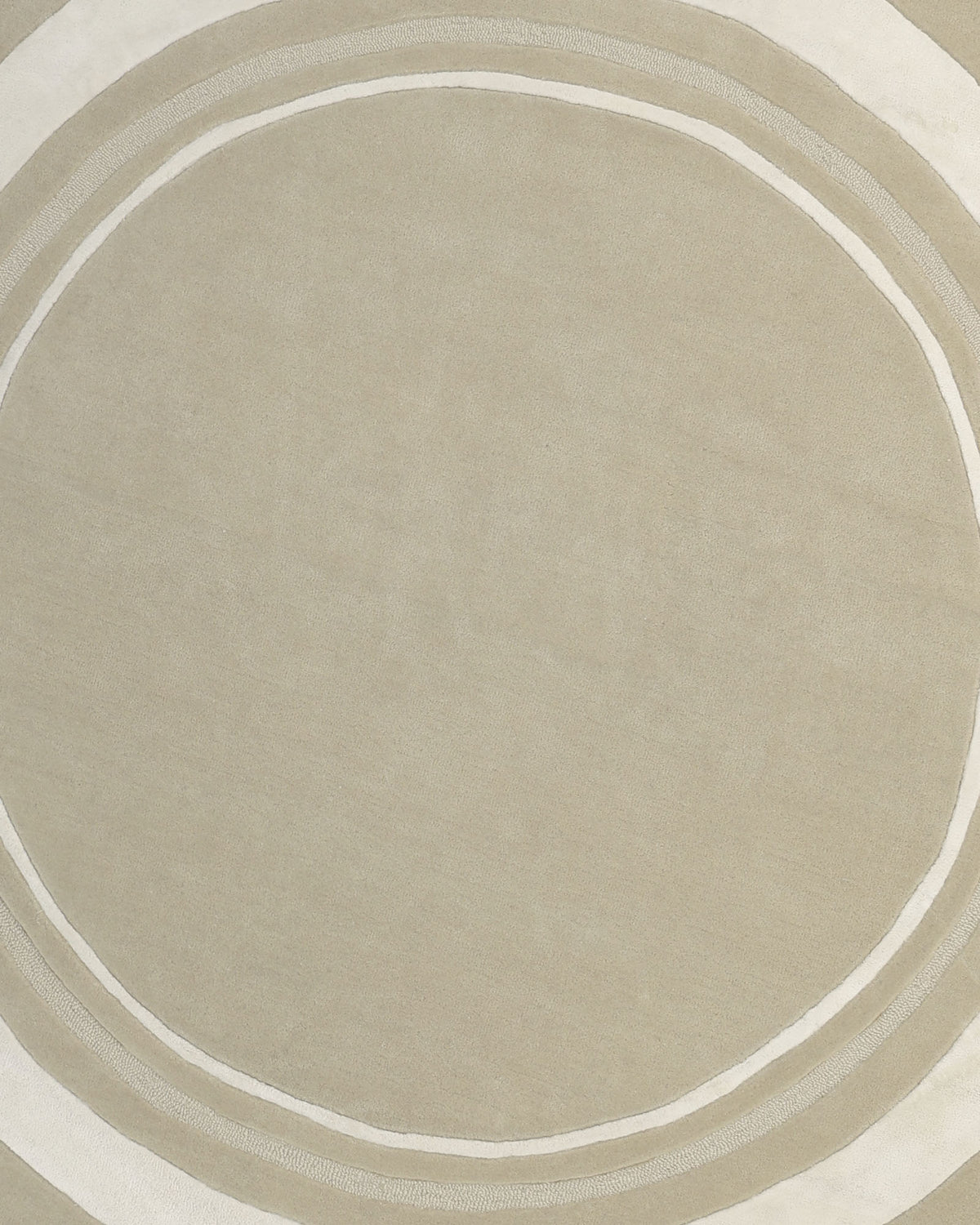 The RAMSHA HOME Multi Color Handmade Rug - HTWV-120 is a handtufted wool rug in soft, neutral beige, featuring two thin, irregular white rings near the edge. Its simple and modern design is showcased against a plain background.