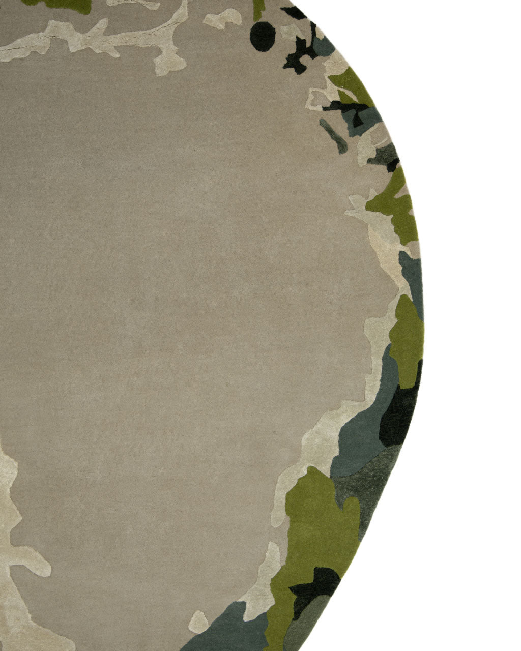 A close-up of the RAMSHA HOME Terra Eclipse Oval Handmade Rug Accent Rug HTWV-201 showcases its abstract camouflage pattern in shades of beige, green, gray, and black, filling the right side and edge of the image—a striking accent piece for any modern interior rug collection.