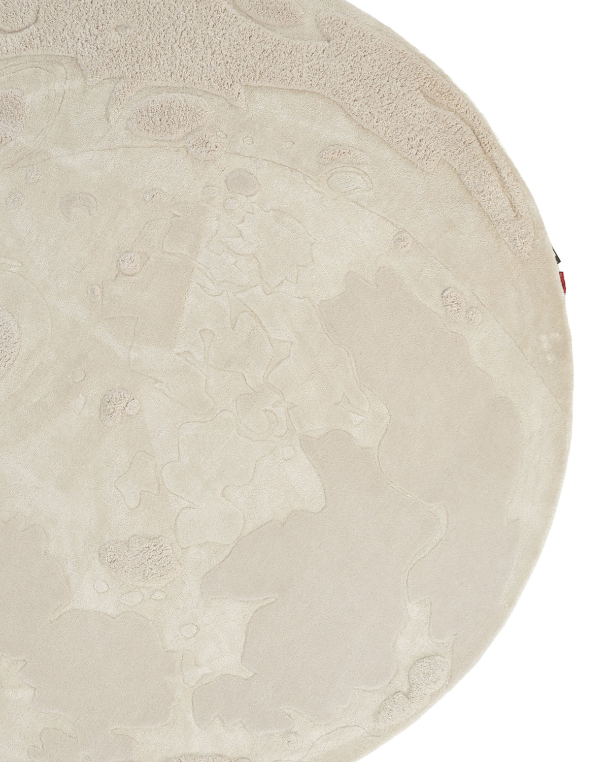 Crafted by RAMSHA HOME, the Natural Color Handmade Area Rug - HTWV-150 (200 cm) is a round area rug in a light, neutral hue. Hand tufted from wool, it showcases a textured pattern with intricate raised areas reminiscent of the moon’s craters. In the image, only part of this elegant rug is visible.