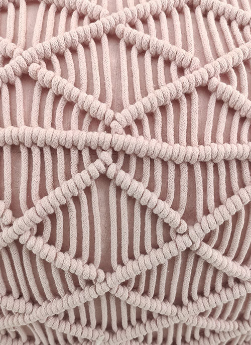 Close-up of the Macrame Cotton Pouf by RAMSHA HOME, crafted from pink cotton with a geometric diamond-shaped macramé pattern in thick knotted cords, adding a chic boho touch.