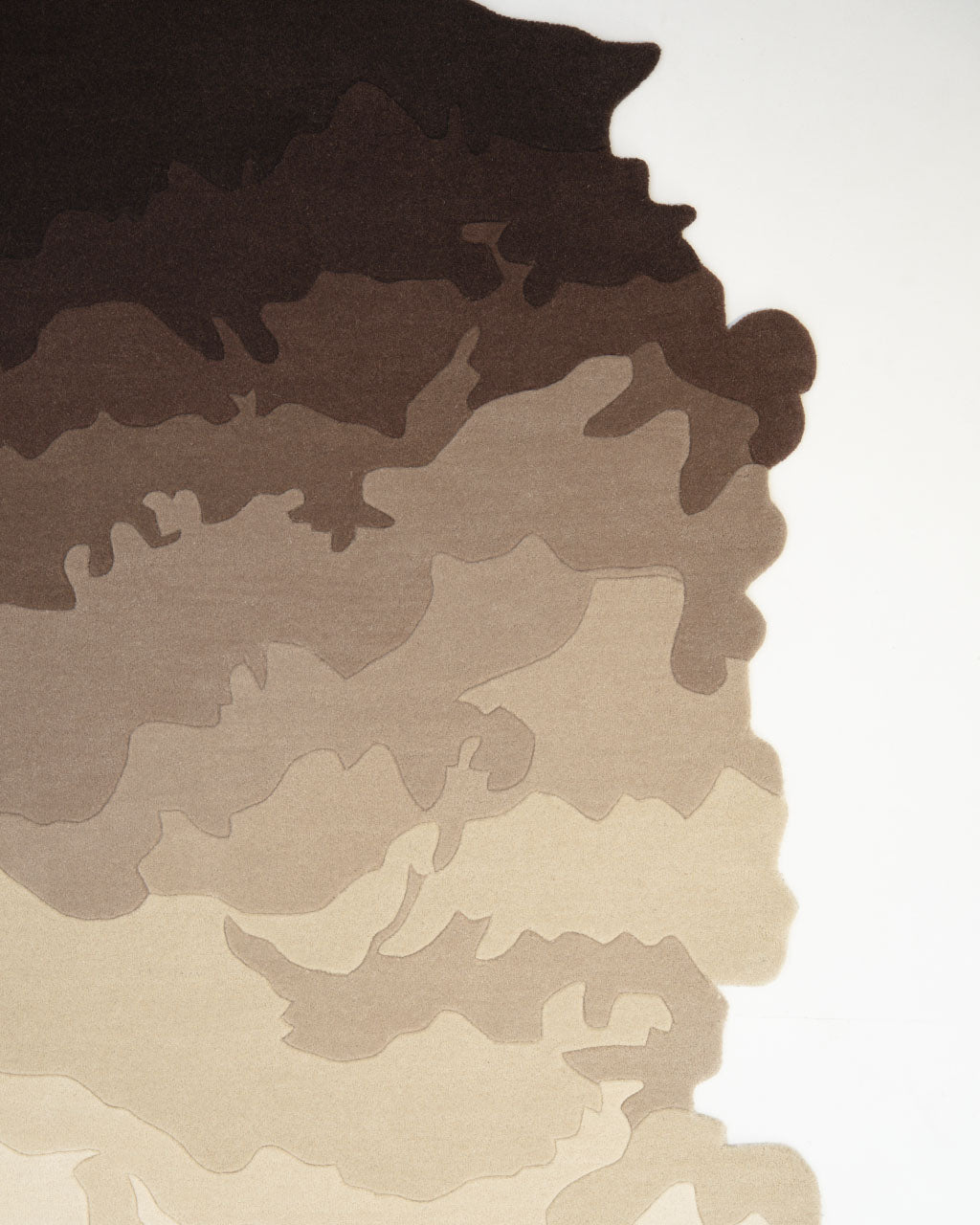 Experience the unique artistry of the Handmade Shape Brown Color Area Rug - HTW 86 by RAMSHA HOME, featuring an abstract pattern of overlapping, wavy shapes in brown and beige tones on a white background reminiscent of contour lines or layers of earth. Its irregular shape adds a distinctive and artistic touch to any room.