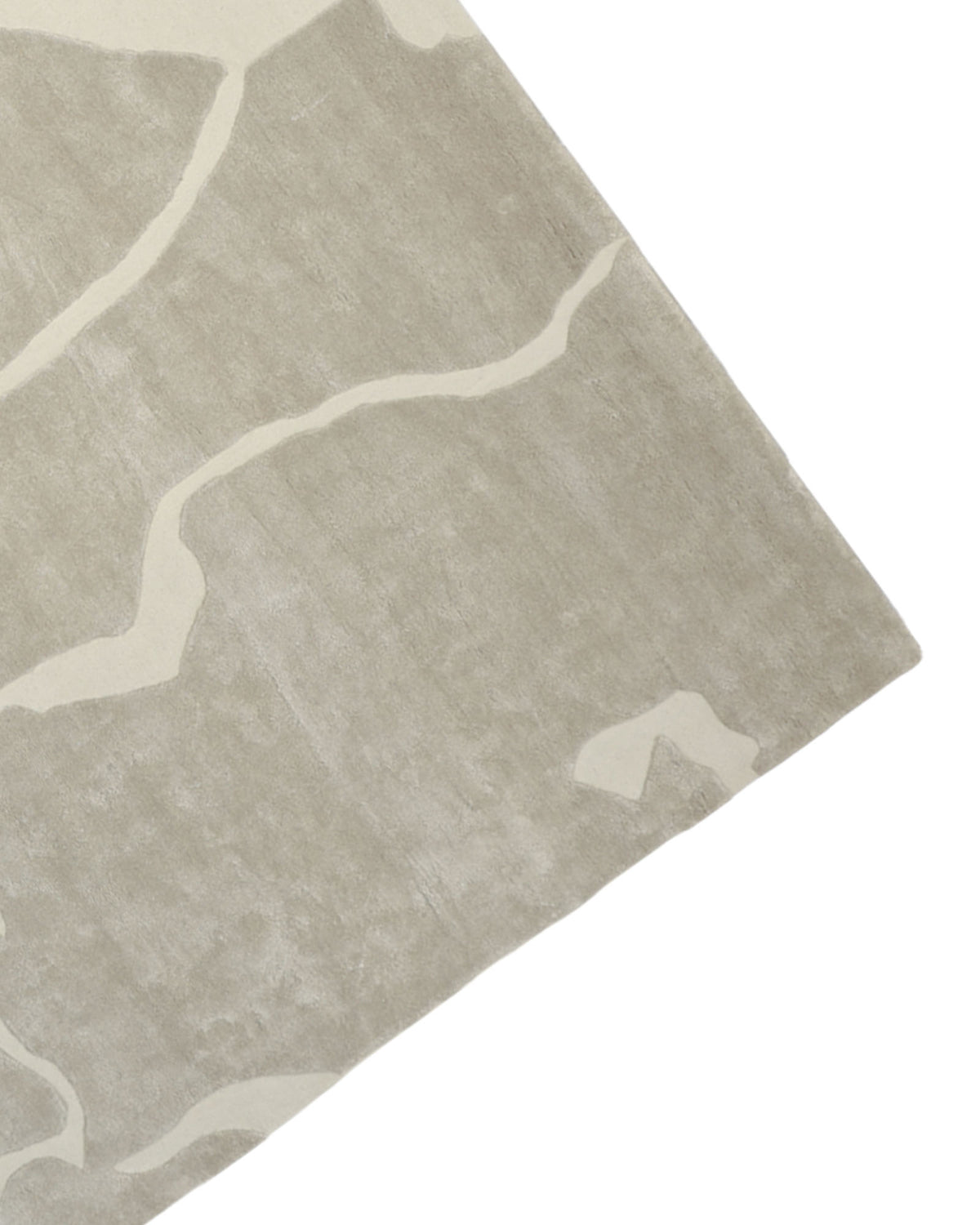 A close-up of the RAMSHA HOME Multi Color Handmade Area Rug - HTWV-132 showcases its rectangular shape in light gray wool viscose, featuring irregular cream-colored abstract lines, viewed from an angled top-down perspective.