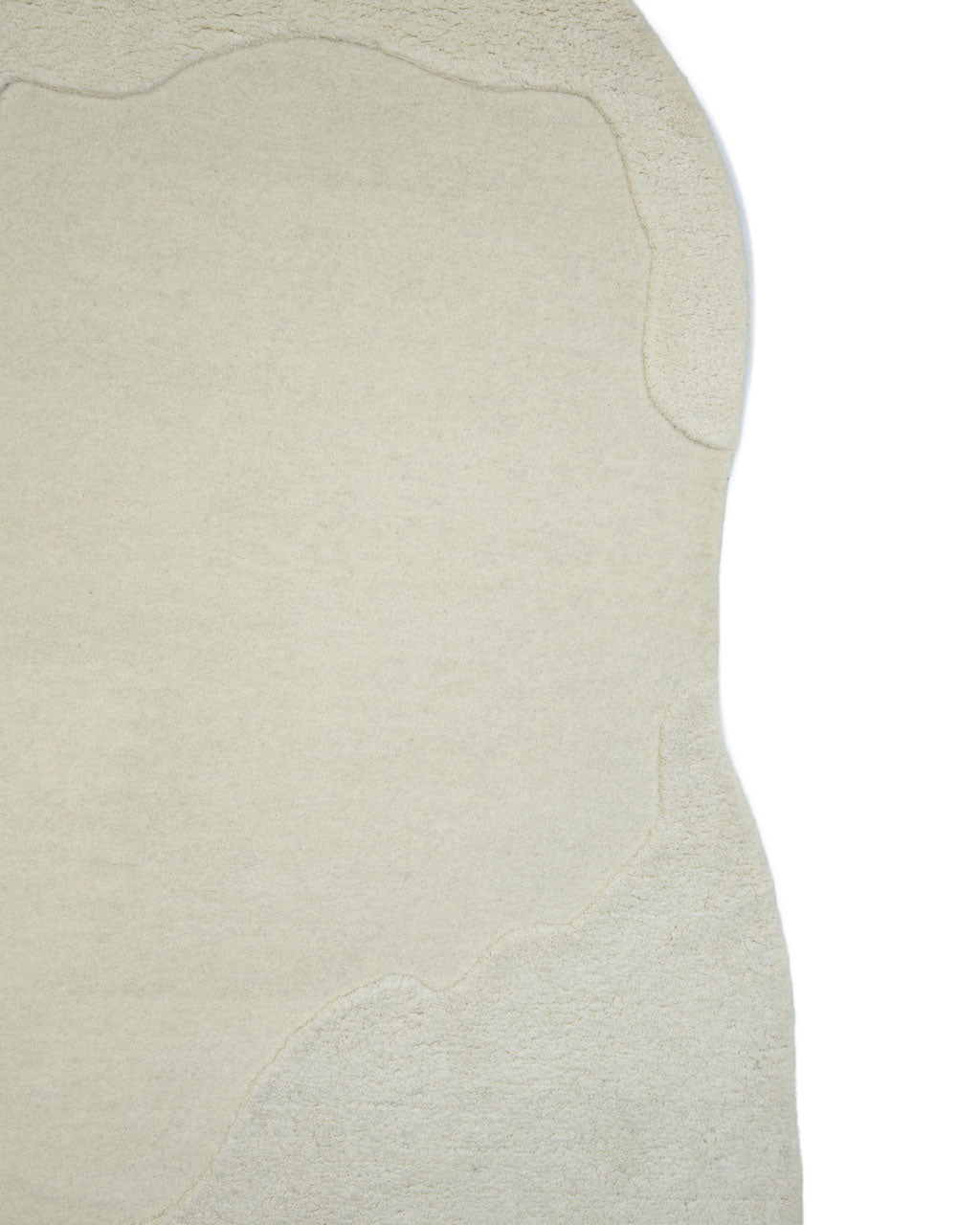The RAMSHA HOME Handmade Shape White Color Area Rug - HTW 101 B features an irregular silhouette in an off-white hue with subtle, raised textured borders, captured against a white background.