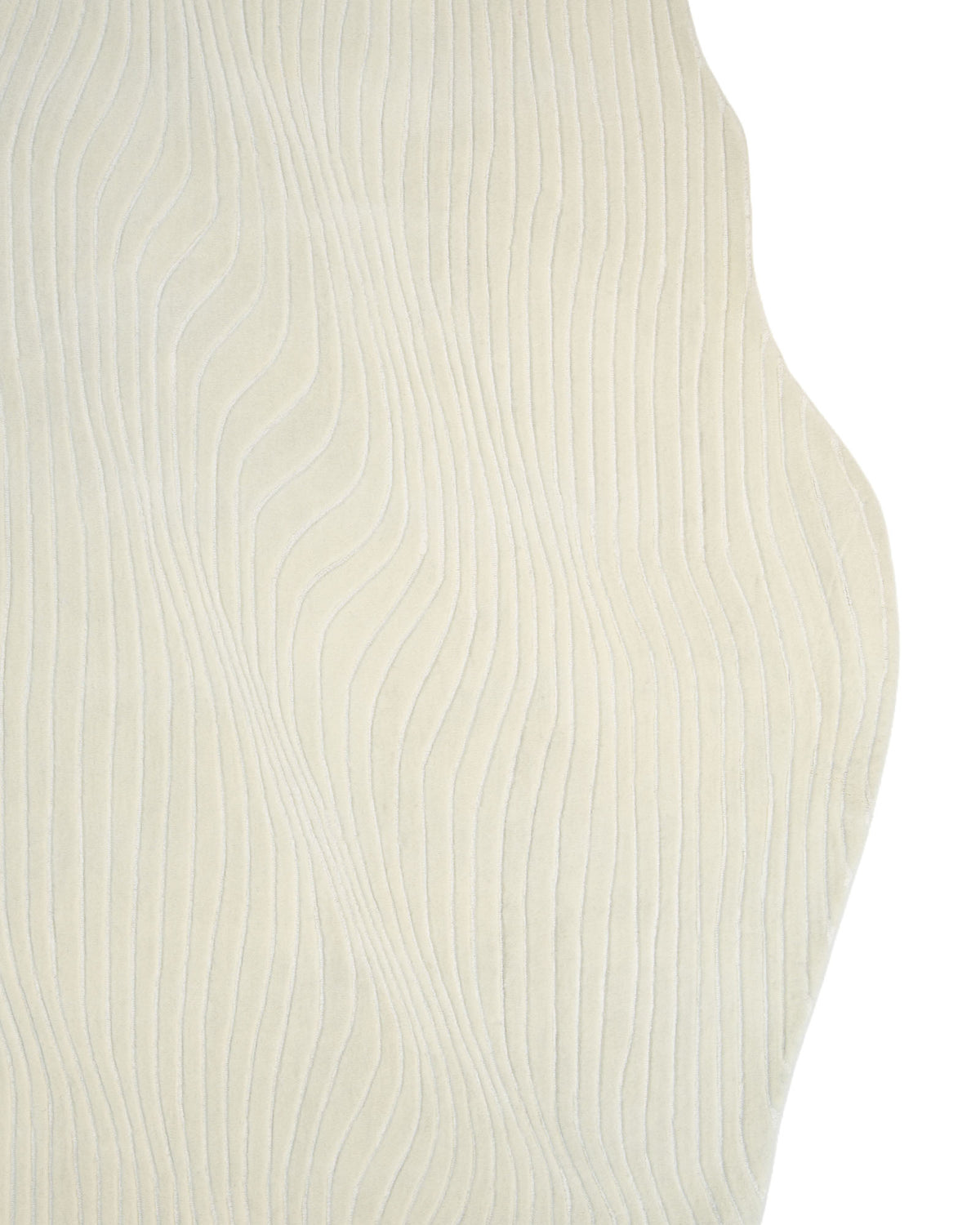 The RAMSHA HOME Hand Tufted Multi Color Decor Rug HTWV-101 features a modern abstract beige design with textured, wavy raised lines that create a flowing pattern. Its irregularly curved right edge contrasts beautifully with smoother lines on the left, making this distinctive rug an eye-catching accent piece for any space. The background is white.