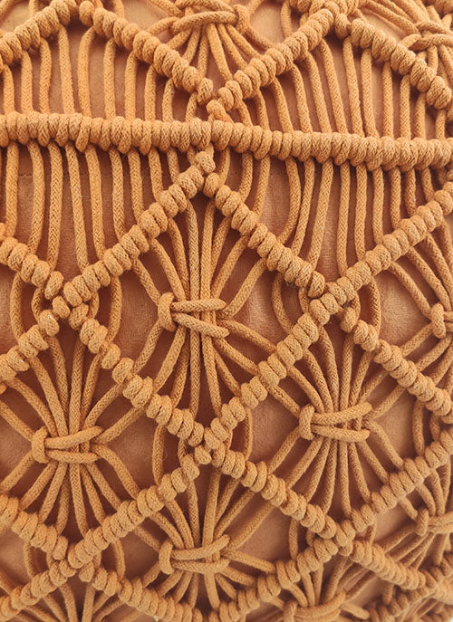 Close-up of a tan boho-style macrame cushion cover with an intricate diamond pattern, perfect to pair with the RAMSHA HOME Macrame Cotton Pouf for a cozy and stylish look.