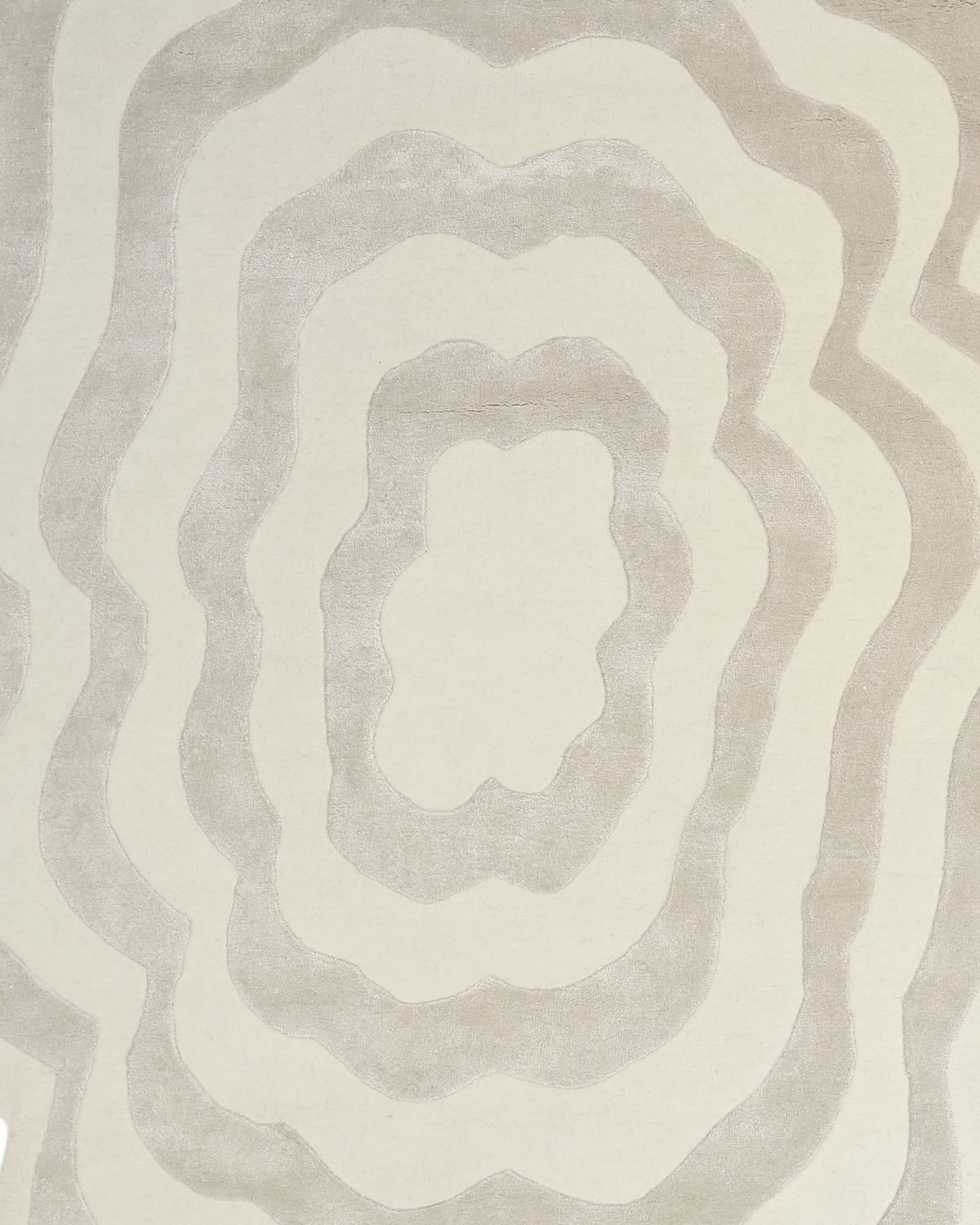 The RAMSHA HOME Beige & Cream Wavy Handmade Area Rug – HTWV-144 showcases concentric, wavy oval shapes in abstract beige and cream tones, reminiscent of topographic contour lines. Its irregular form adds a modern touch to any space.