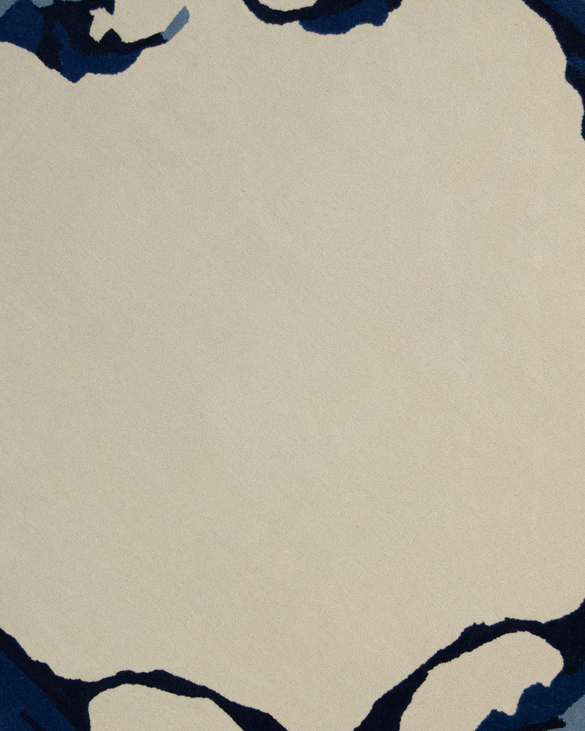 The Round Handmade Hand Tufted Carpet HTW-64 by RAMSHA HOME features a minimal and modern design with a central beige area, reminiscent of contemporary area rugs. Irregular dark blue and navy shapes border the edges, creating a distinctive frame-like effect.