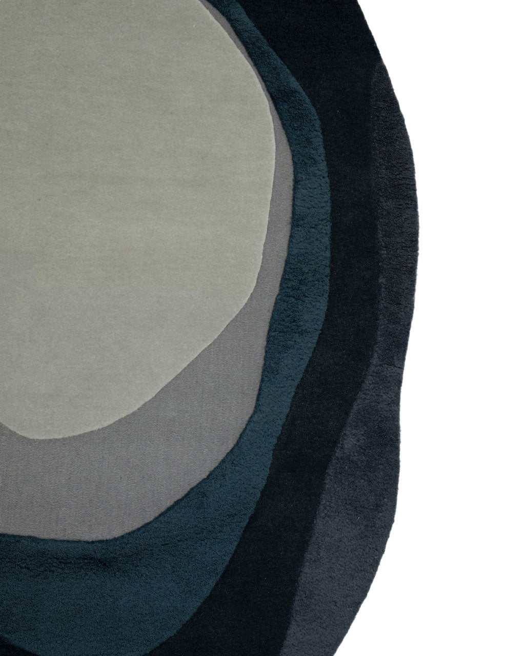 Partial view of the RAMSHA HOME Handmade Layered Abstract Shaped Rug HTW 131 (200 x 300 cm), featuring a hand-tufted, irregular design in shades of gray, black, and teal reminiscent of ripple patterns or sediment layers, displayed on a white background.