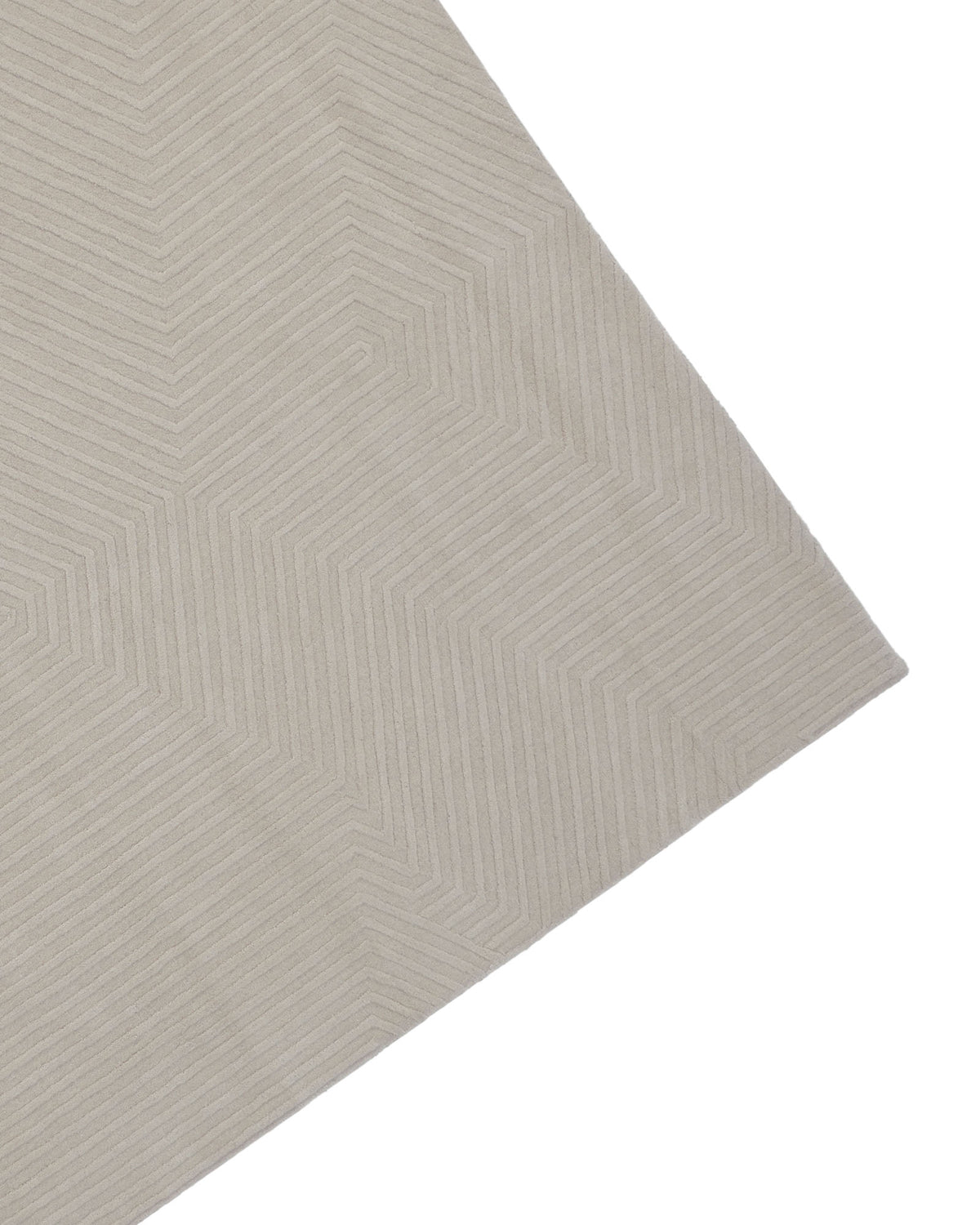 A close-up of the RAMSHA HOME Home Decor Handmade Area Rug - LKH-014 (200x300 cm) in beige, showcasing its Scandinavian-inspired geometric zigzag pattern. Only a corner of this area rug is visible against a white background.