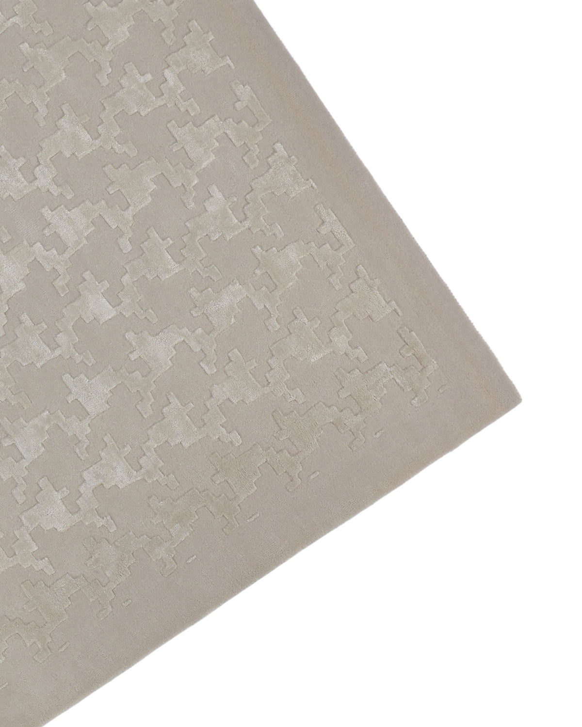 A close-up of the Handmade Rectangle Living Room Rug HTWV-131 by RAMSHA HOME showcases its hand-tufted craftsmanship and subtle, raised geometric houndstooth pattern reminiscent of abstract puzzle pieces. This neutral rug effortlessly brings understated elegance to any space.