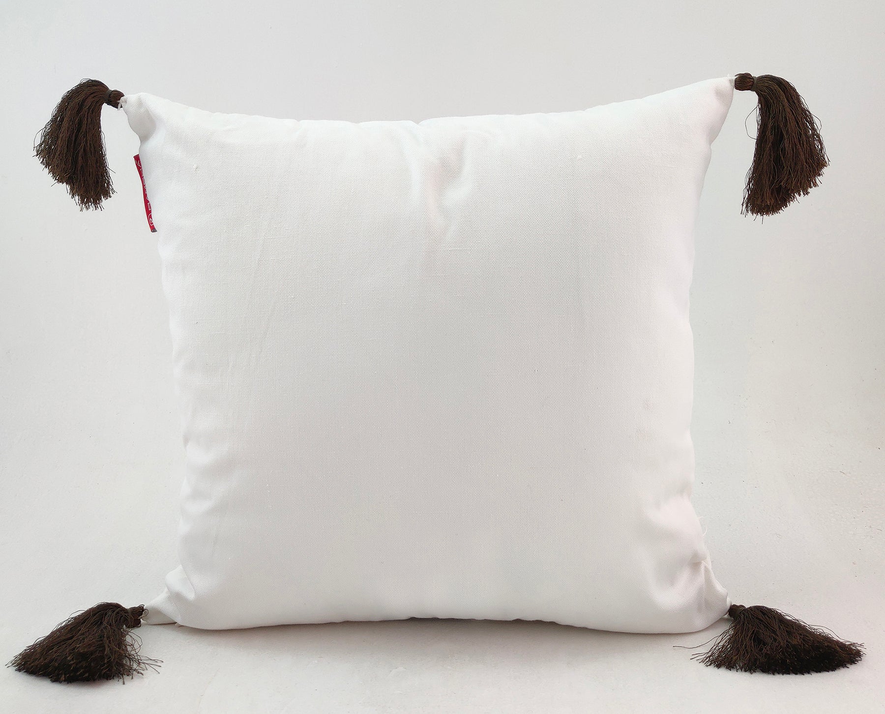 The RAMSHA HOME White & Brown Cushion CS-138 is a square white polyester cushion with brown tassels on each corner, ideal for adding stylish flair to your home decor.