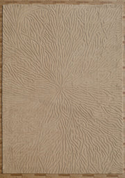 A Handmade Beige Rug with Organic Tree-Inspired Pattern (LKH-025) by RAMSHA HOME lies on a wooden floor, showcasing its intricate embossed high-low design of raised, wavy lines that radiate outward like tree rings or flowing water.