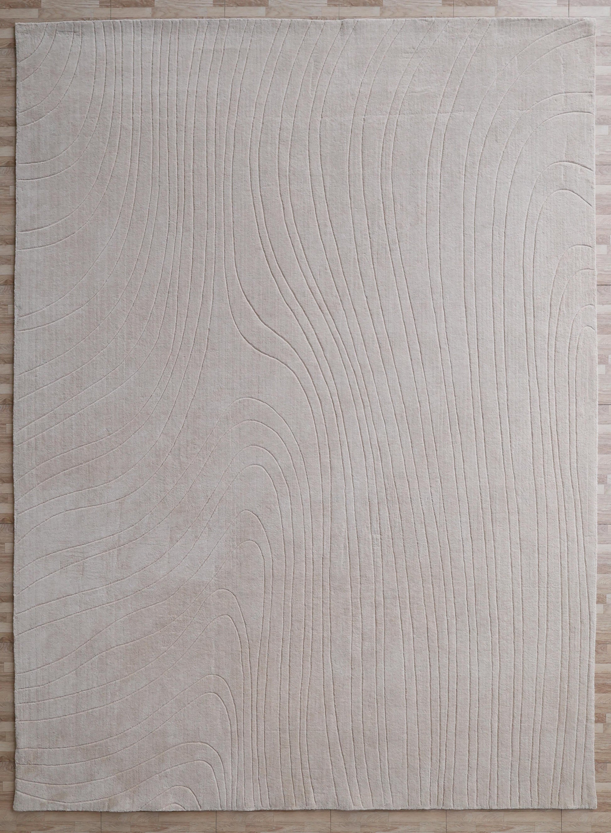The RAMSHA HOME Modern Handmade Area Cream Color Rug (300x400 cm, LKH-046) features a rectangular shape with subtle wavy raised lines in an abstract pattern, shown on a light wood floor.