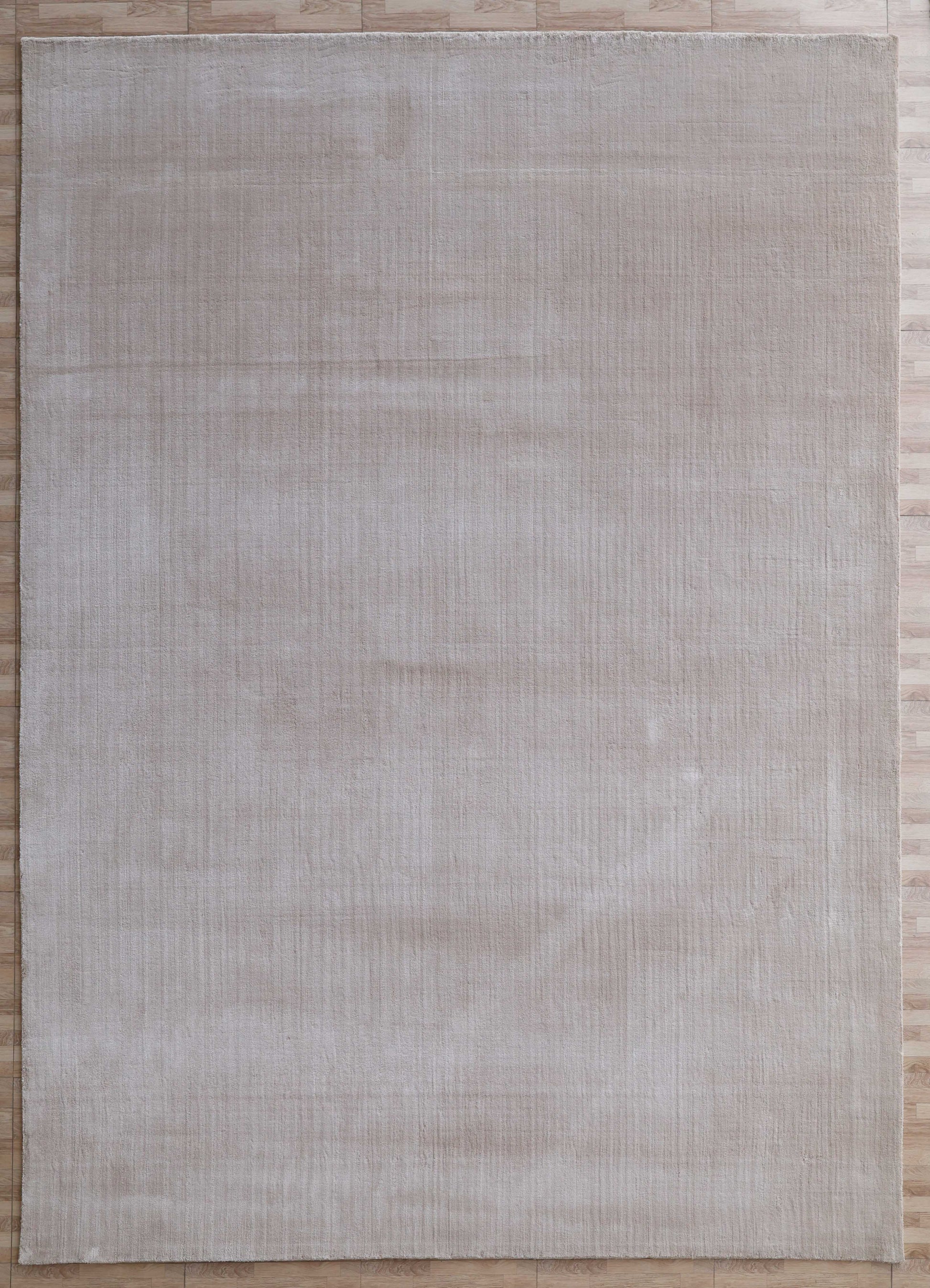 The RAMSHA HOME Handmade Plain beige Area Color Rug 300x400 cm (LKH-047) rests on a light brown wooden floor, adding subtle texture with its rectangular cream hue.