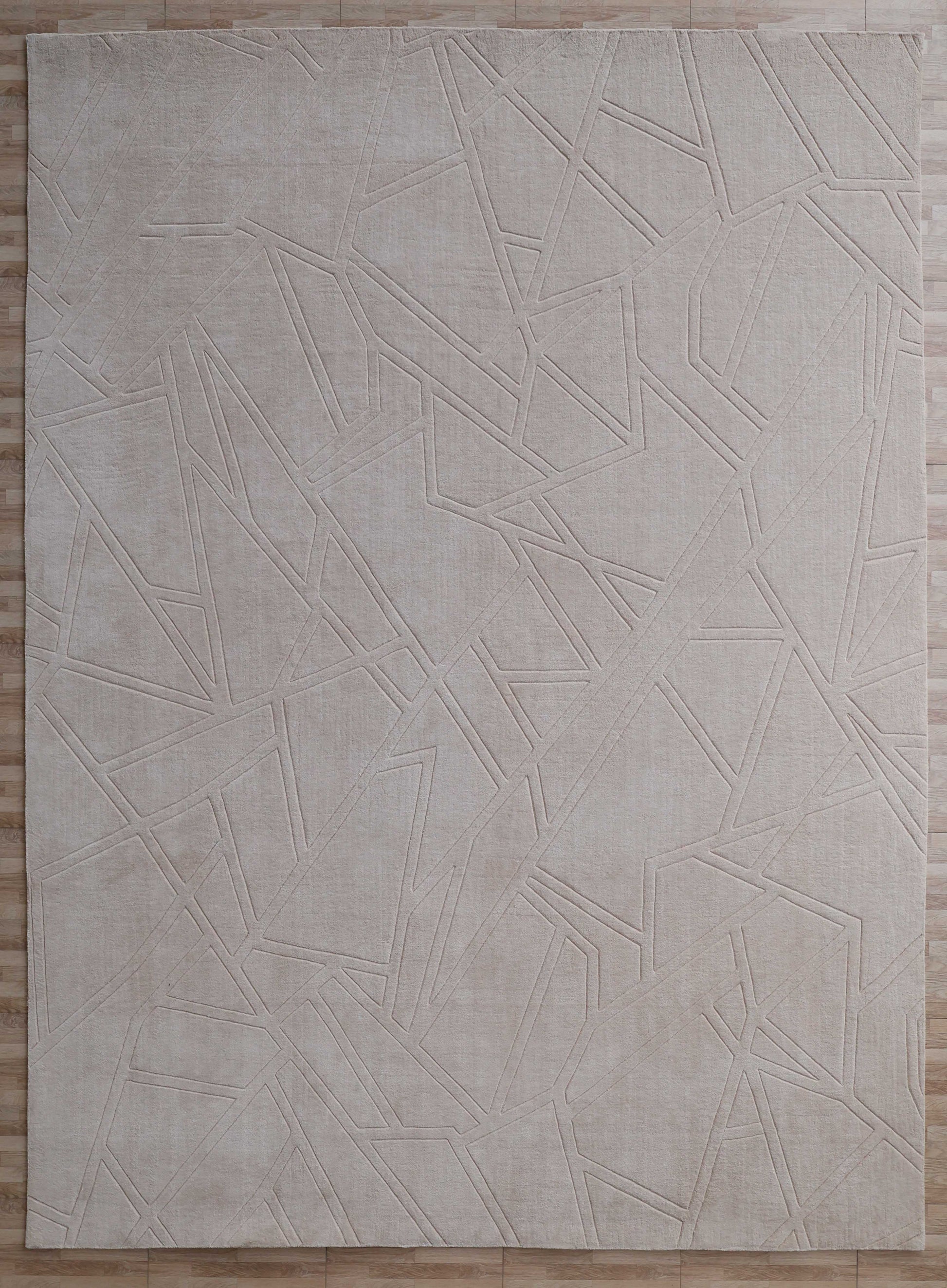 The Rectangle Home Decor Cream Color Handmade Area Rug (300x400 cm, LKH-045) by RAMSHA HOME features an abstract geometric pattern in cream on a light wooden floor, adding modern elegance and texture to your space.