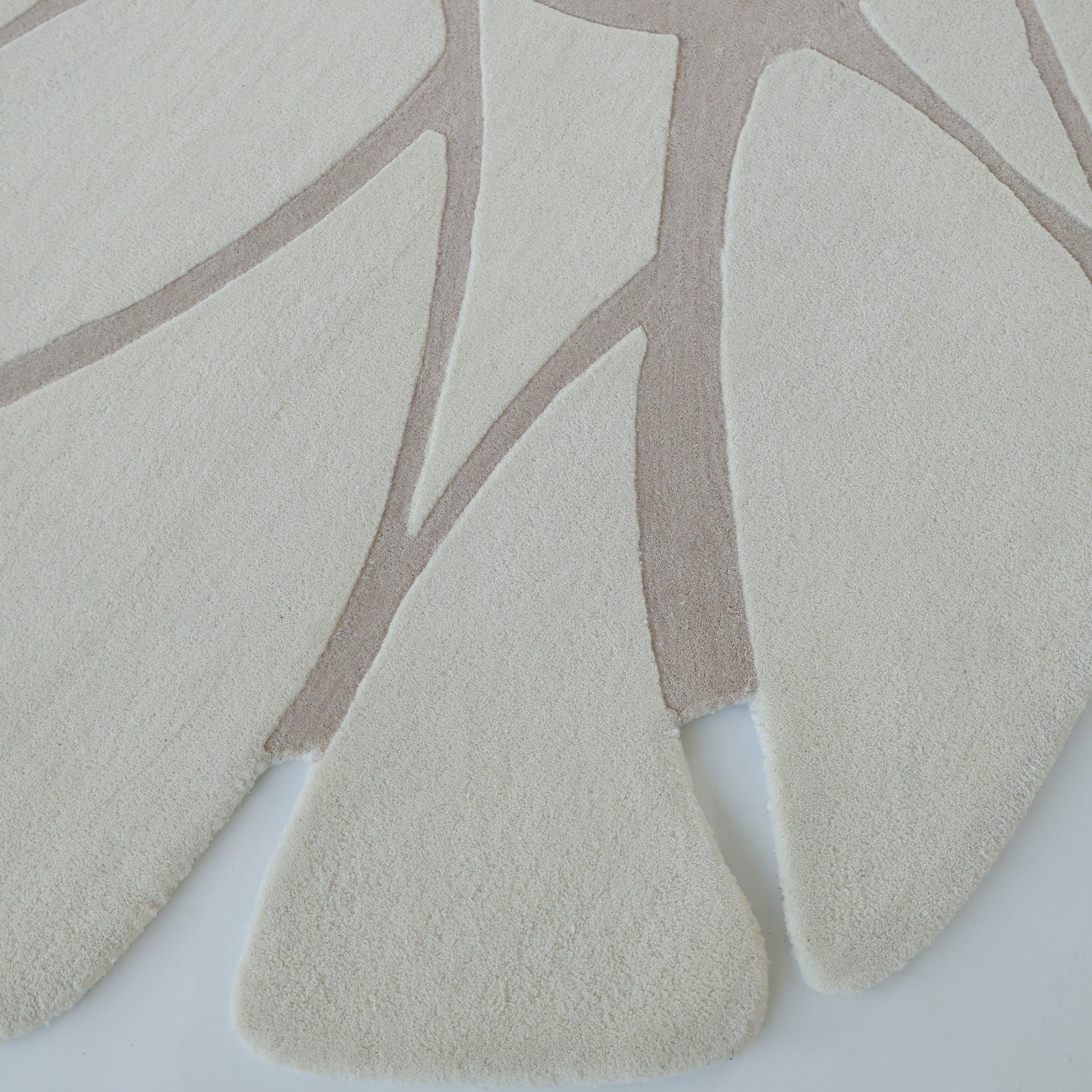 The Luxurious Brown & Beige Color Round Hand Tufted Rug (HTW 58, 200cm) by RAMSHA HOME features elegant organic shapes and a plush texture, making it a stylish modern addition to any space.