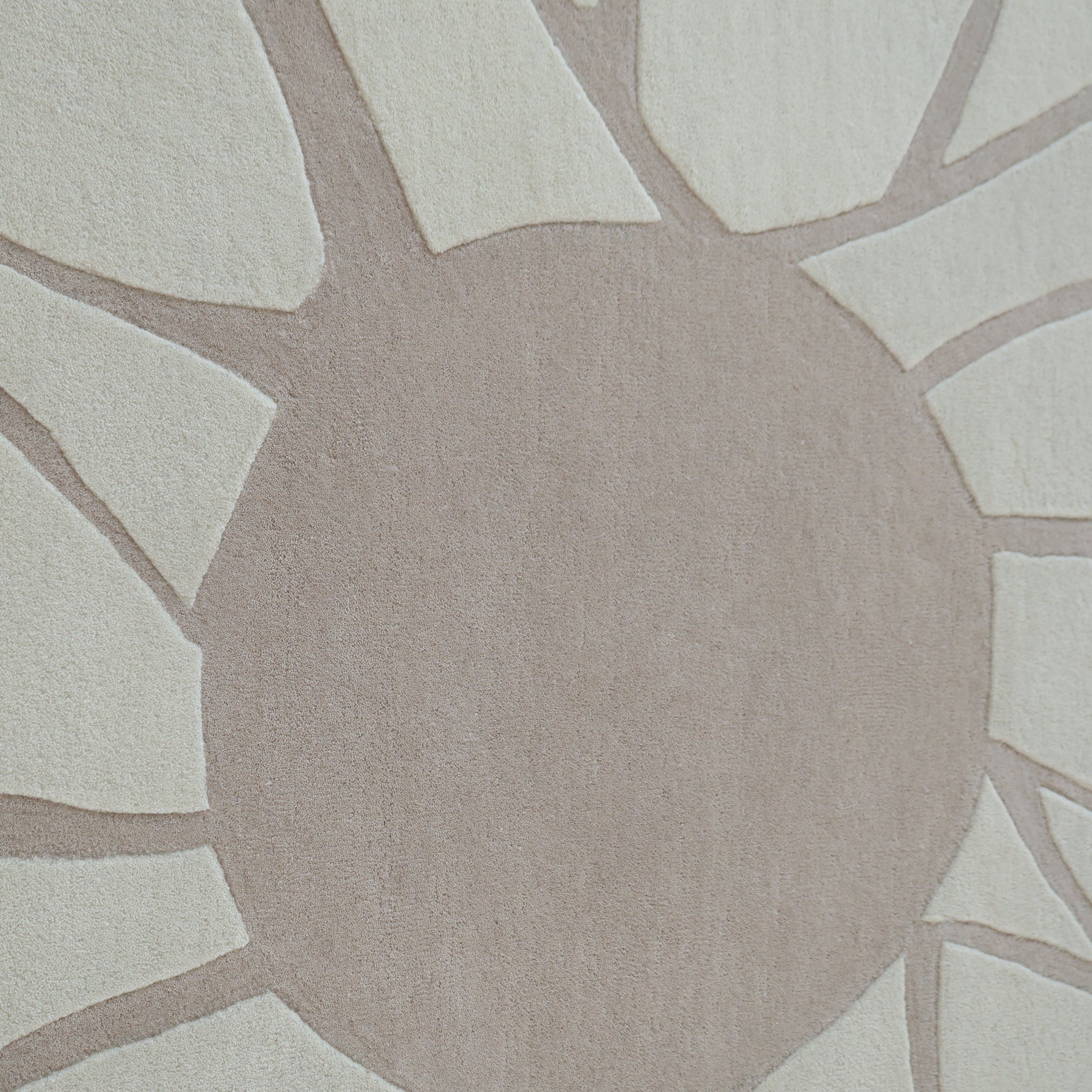 The RAMSHA HOME Luxurious Brown & Beige Color Round Hand Tufted Rug - HTW 58 (200cm) features a modern design with a large central circle and radiating lines on a light background, evoking a stylized sun or flower.