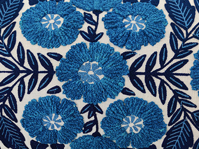 The RAMSHA HOME Blue Flower Embroidery Cushion CS-267 showcases blue embroidered flowers with dark blue leaves and stems on white fabric in a stylish, symmetrical design—ideal for elevating your home décor.