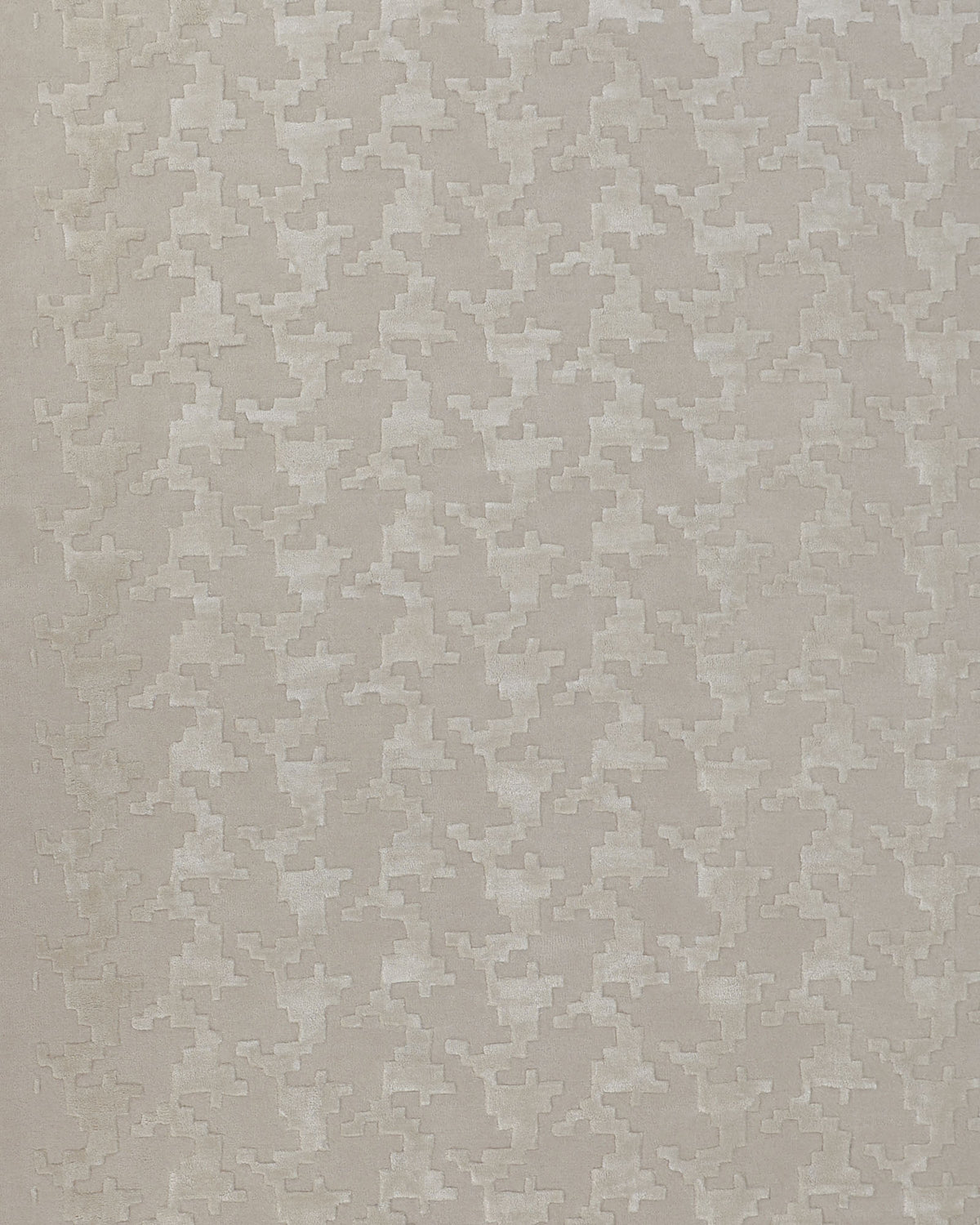 A close-up of the RAMSHA HOME Handmade Rectangle Living Room Rug HTWV-131 highlights its beige fabric adorned with a subtle geometric houndstooth pattern, featuring small, angular shapes woven in a slightly lighter shade.