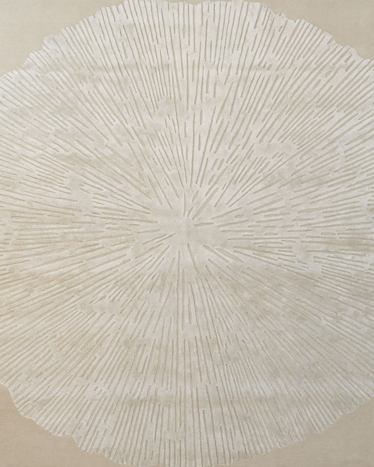 A textured, circular beige pattern reminiscent of tree rings or sun rays radiates across a neutral background, forming a subtle, organic design that is perfect for a contemporary wool rug. The Hand-Tufted Carpet For Home Decor HTWV-76 by RAMSHA HOME offers an elegant and versatile neutral floor covering that enhances any modern living space.
